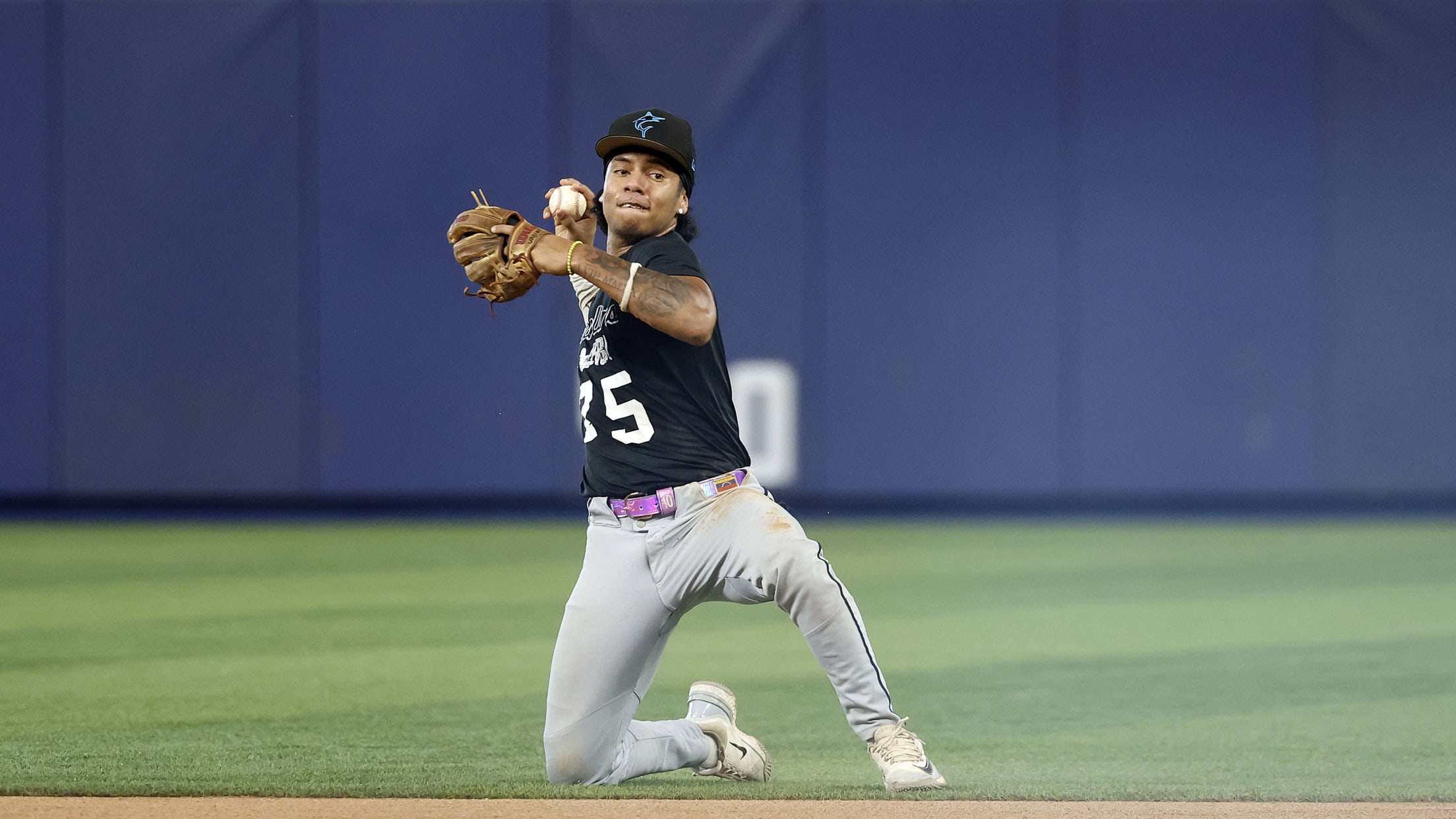 The infielder prepares to throw the ball from their knee.