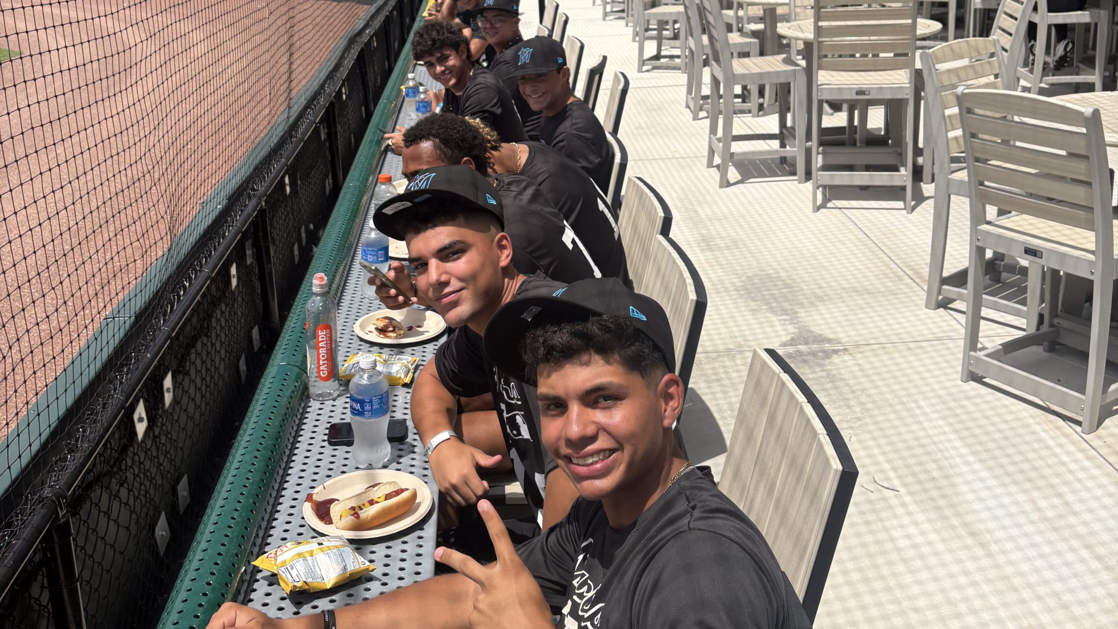 Players pose for a photo while eating during the Marlins Nike RBI All-Stars Southeast Regional tournament.