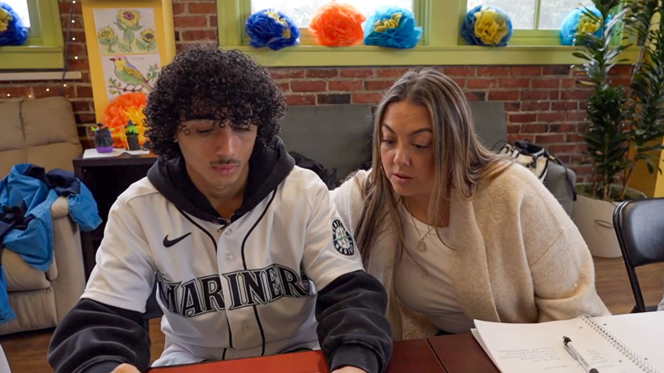 Image of young fan reviewing paperwork.