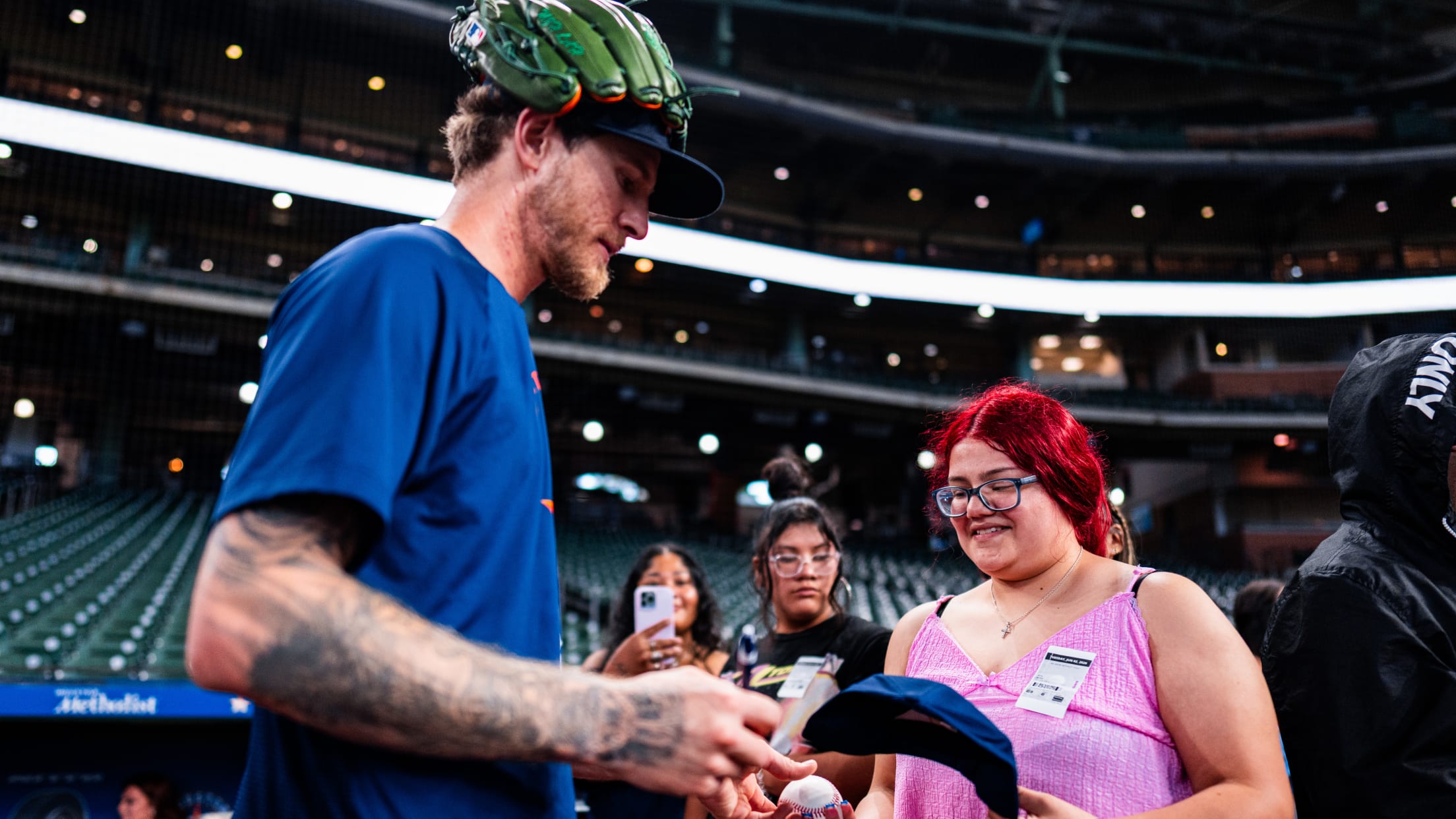 Josh Hader signs a baseball and cap as he meets with Houston Astros fans.