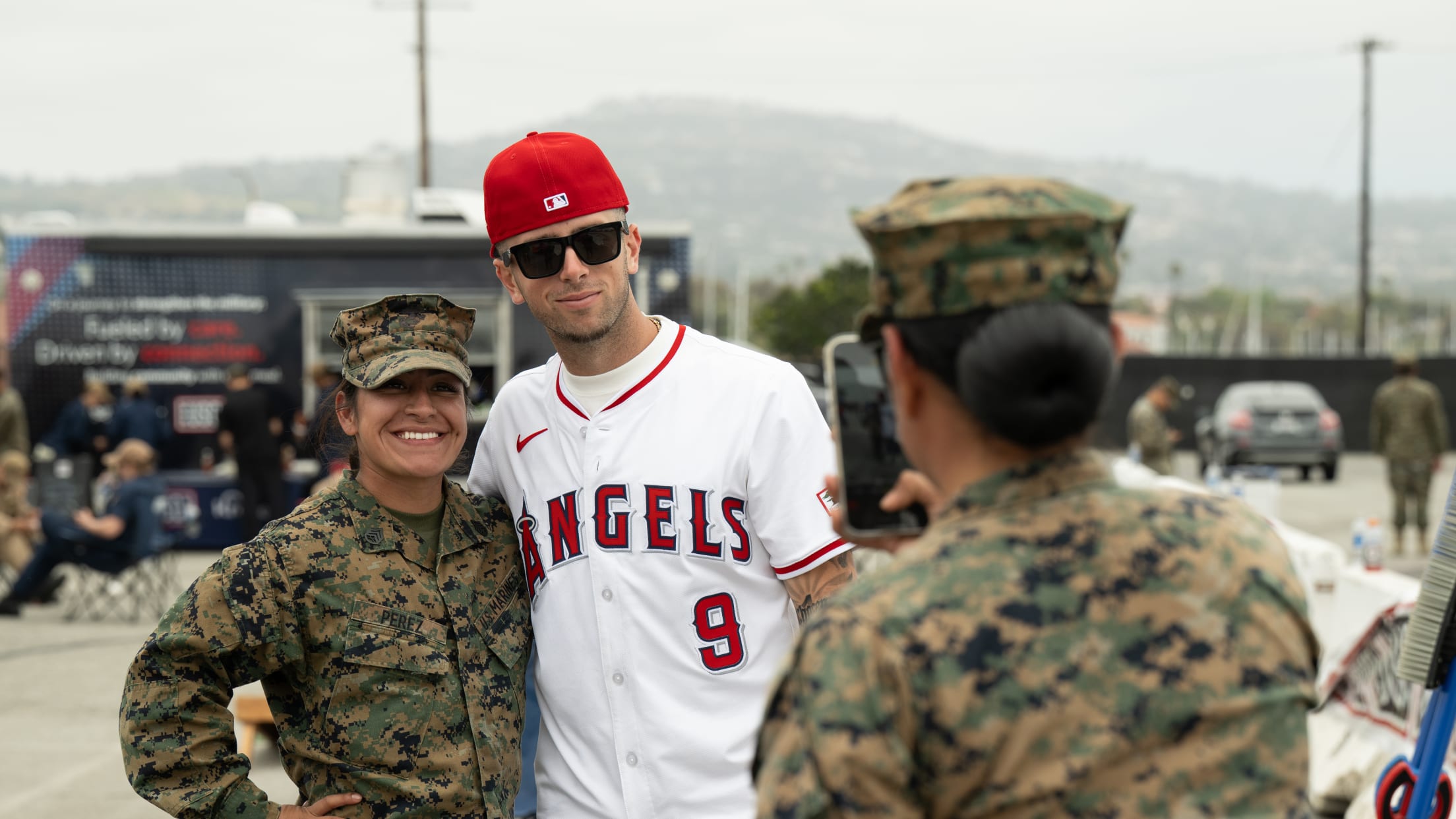 Zach Neto takes a picture with a United States service member.