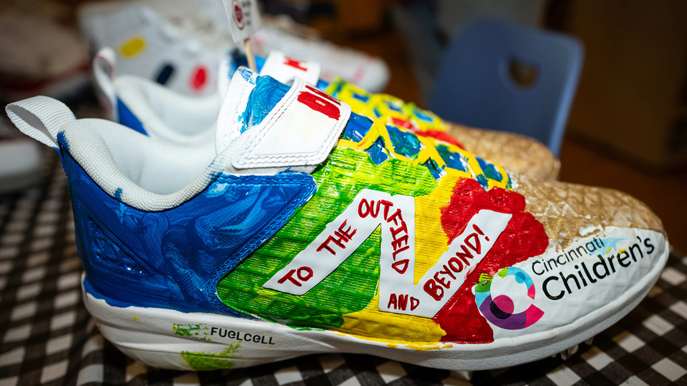 A pair of cleats belong to Dane Myers, whose favorite animated movie is “Toy Story,” with the words "To the Outfield and Beyond!" painted on them.