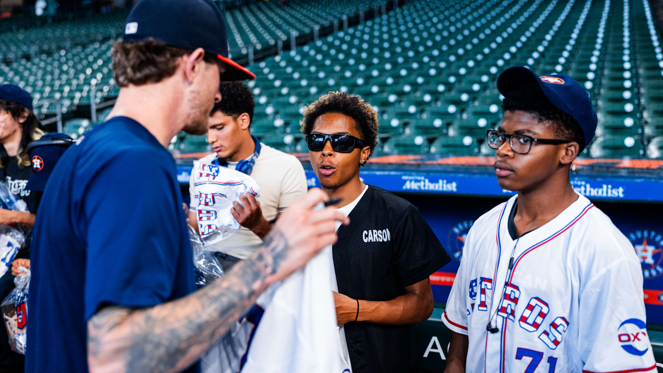 Josh Hader signs a jersey for fans ahead of the Houston Astros matchup against the Marlins.