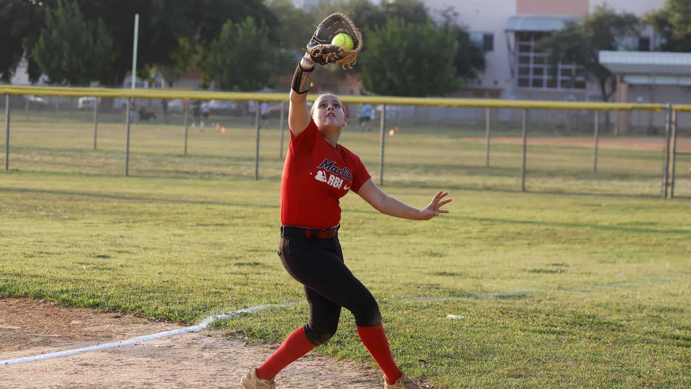 The first baseman gets under a fly ball at the Marlins Nike RBI Softball Classic.