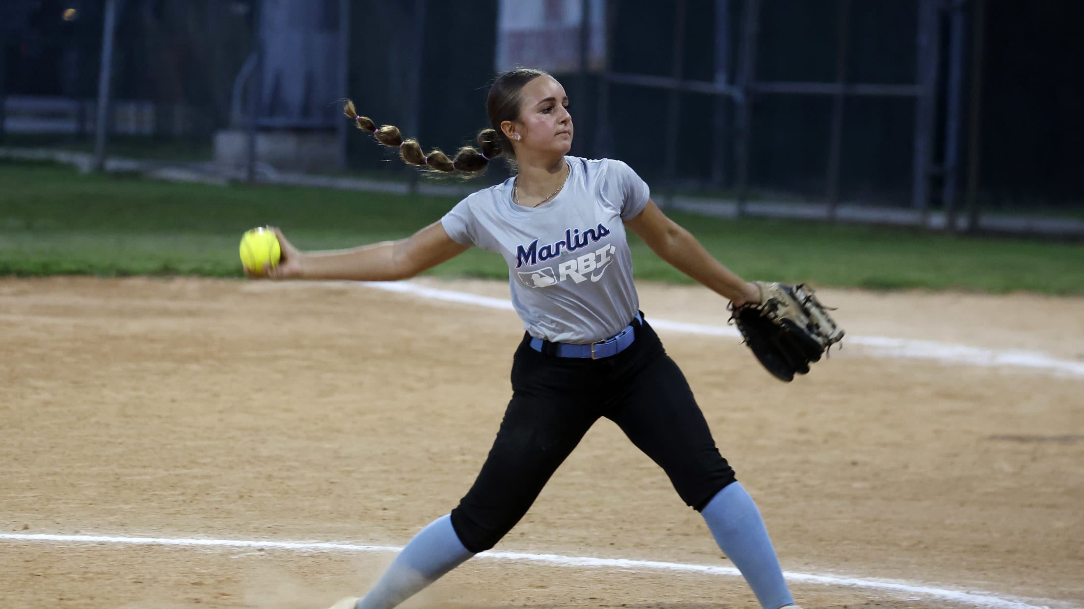The pitcher winds up and readies to release the softball at the Marlins Nike RBI Softball Classic.