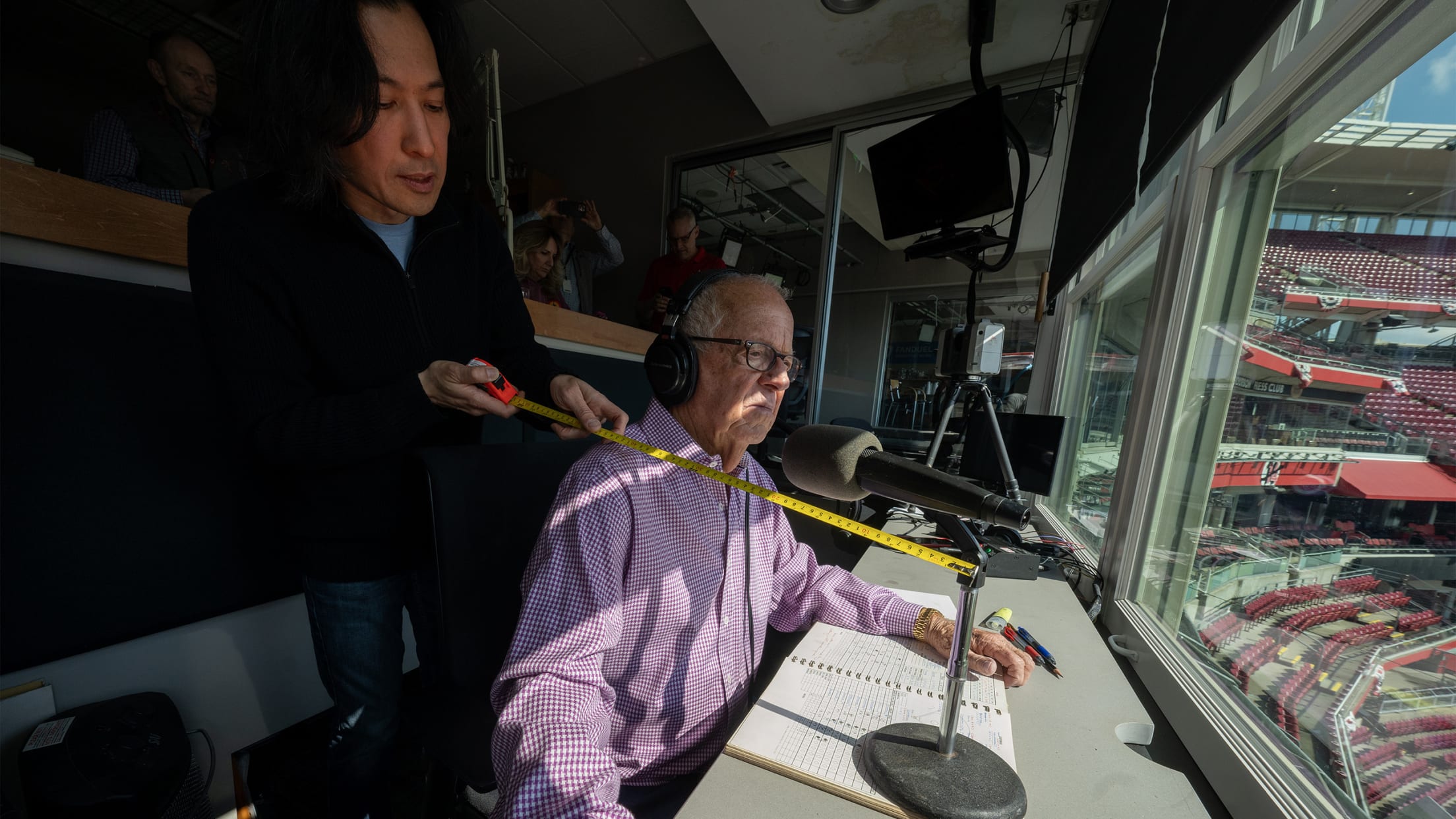 Marty getting measured by sculptor Tom Tsuchiya for his likeness from the broadcast booth.