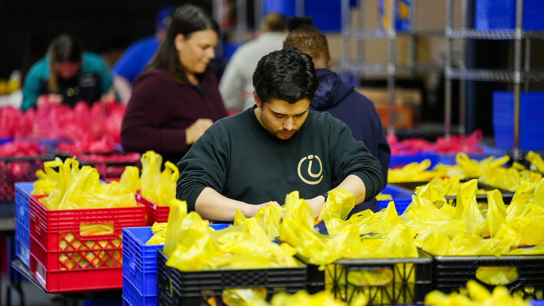 Image of Mariners staff packing donations.