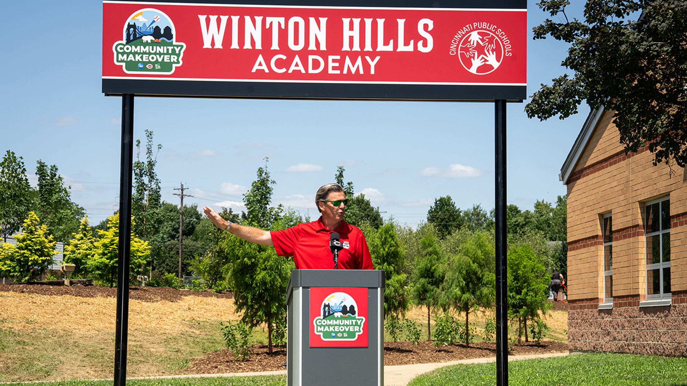 Reds President and CEO Phil Castellini gives a speech outside Winton Hills Academy.