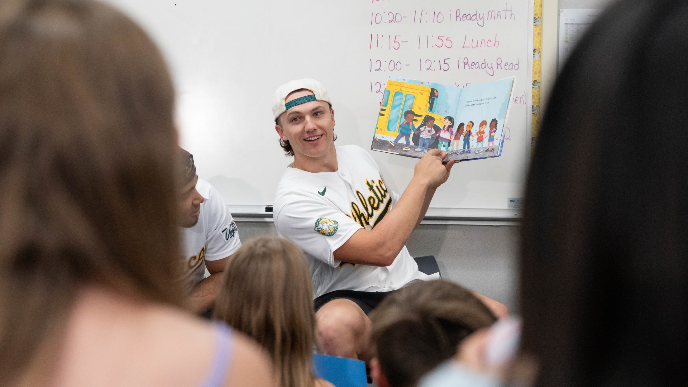 Zack Gelof reads a children's book at Lichen elementary school.