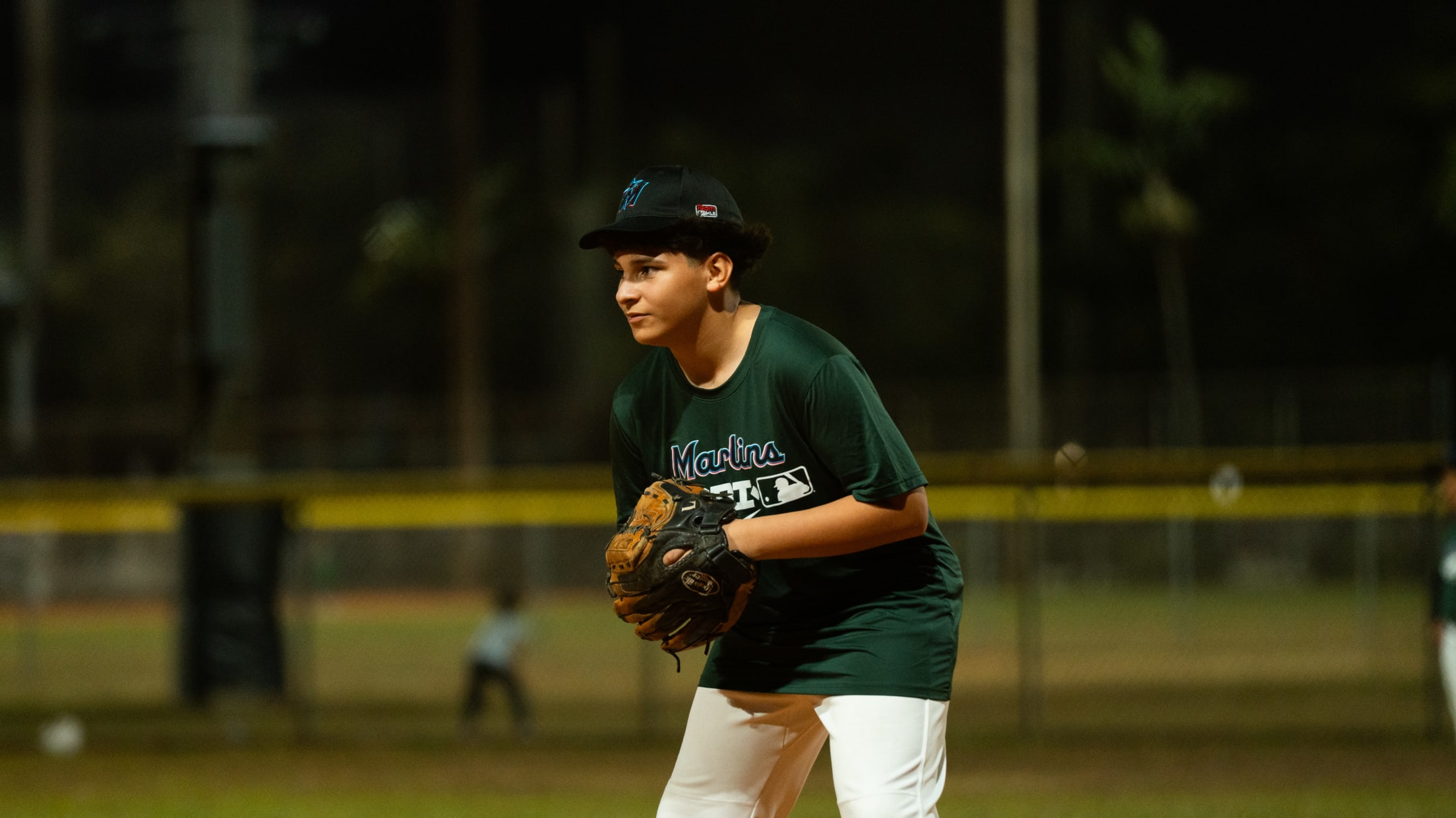 An infielder gets ready for the next pitch at the Marlins Nike Jr. RBI program.