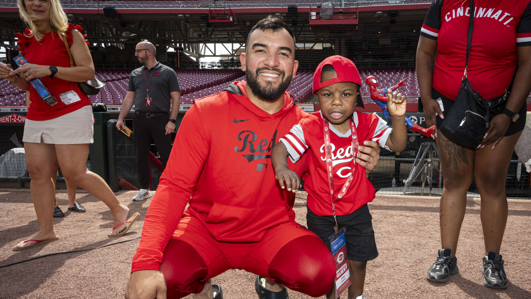 Jose Trevino is all smiles with a child from the Make-A-Wish Foundation at Great American Ball Park.