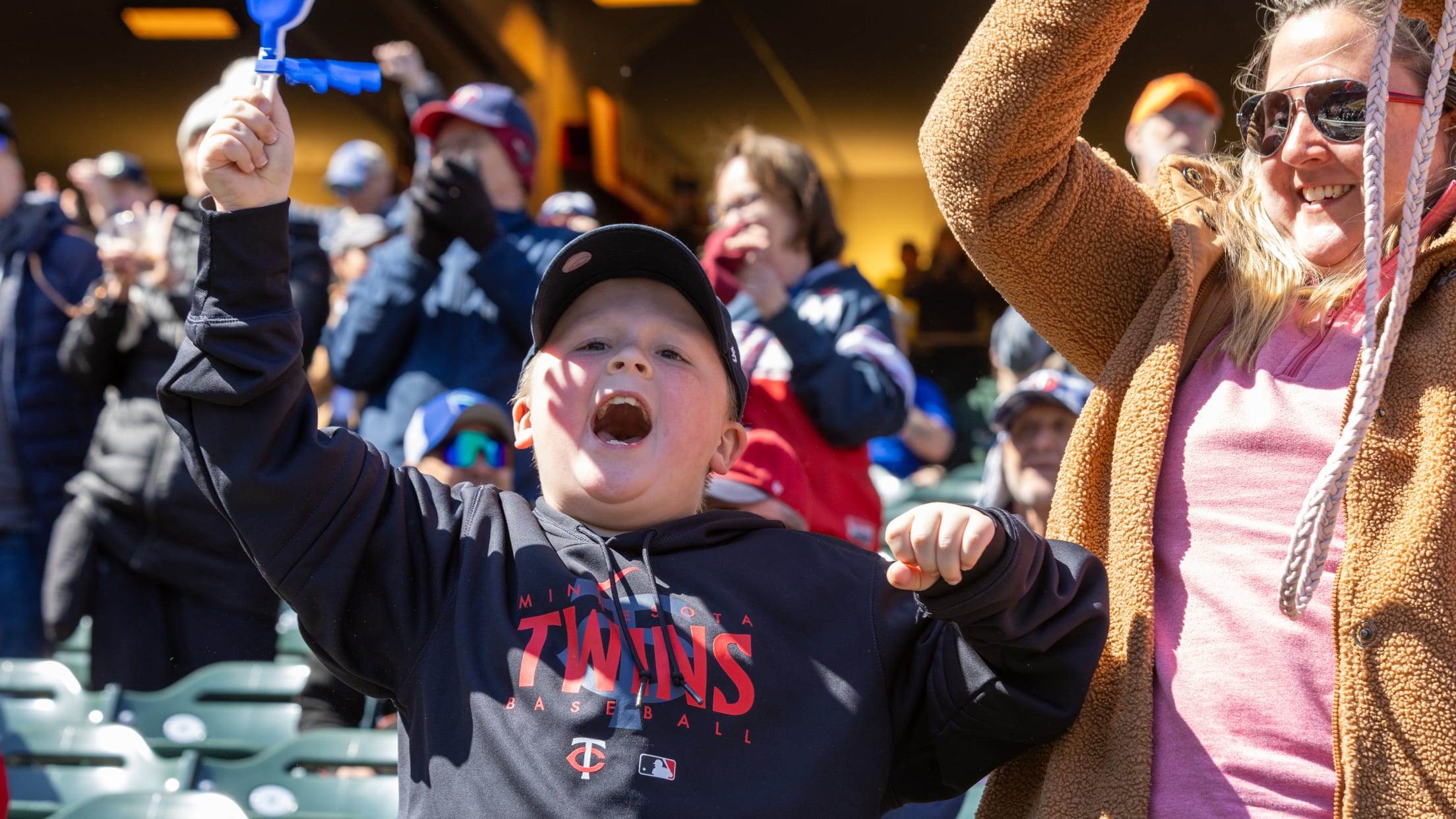 Child and adult cheering on the Twins in the Family Section