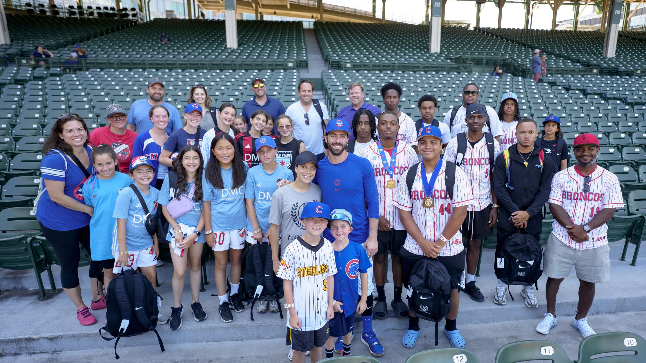 Dansby Swanson takes a picture with fans at Wrigley Field.
