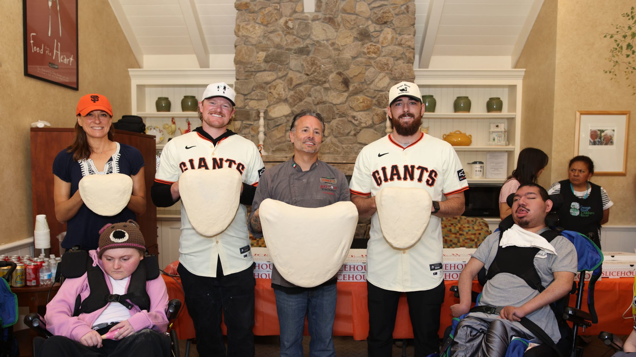 Logan Webb takes a group picture at an event.
