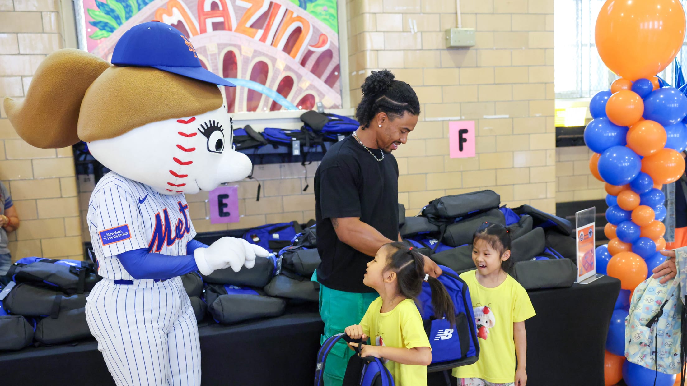 Francisco Lindor hands out backpacks to students at a school in New York City.