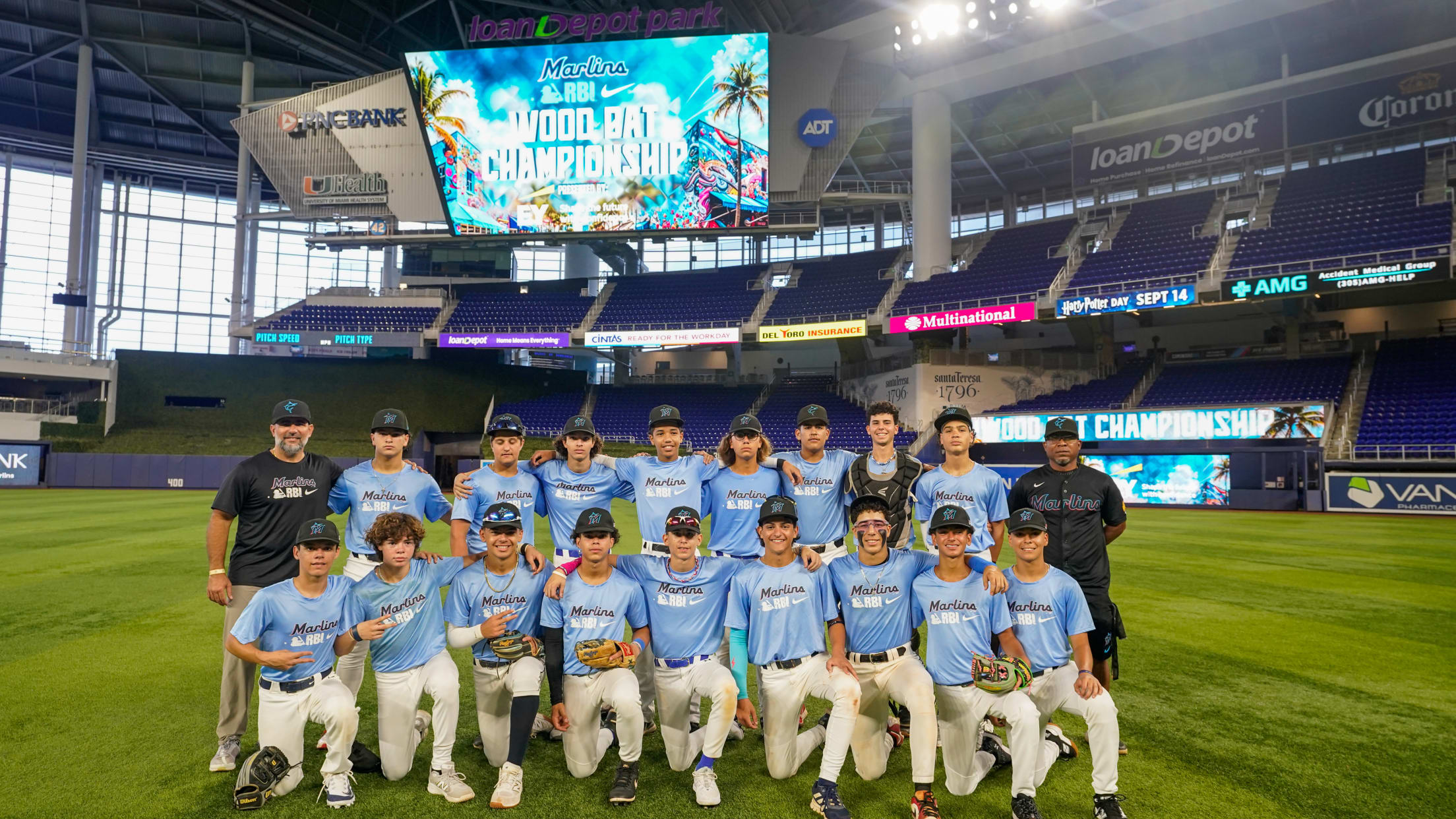 Miami Nike RBI players take a team photo on the field at loanDepot Park.