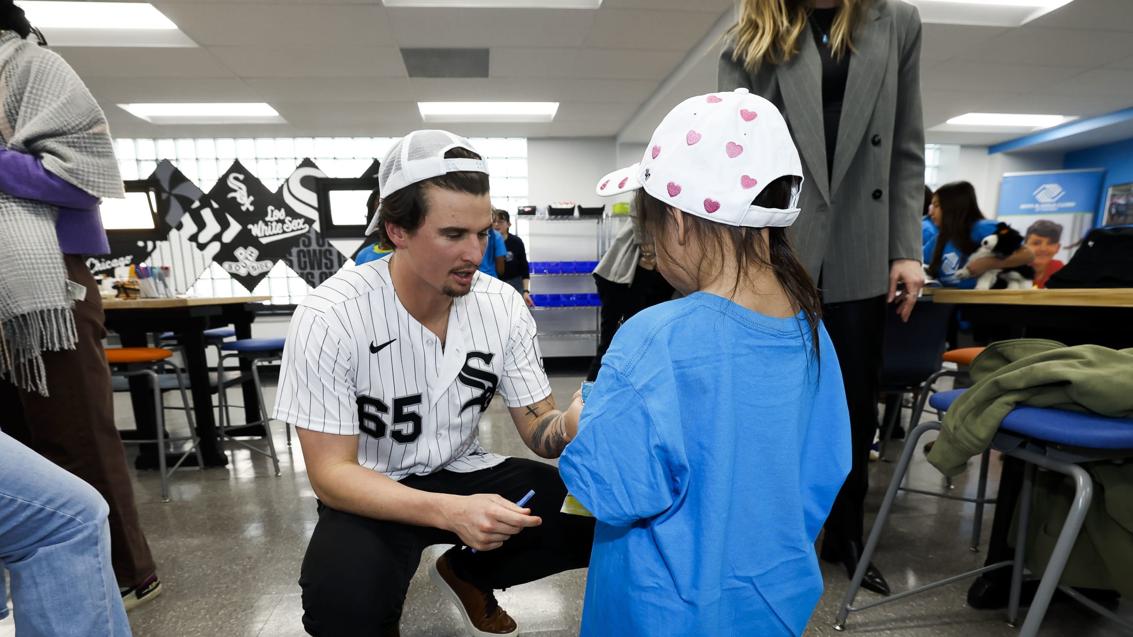 Davis Martin interacts with a young fan at the Boys & Girls Club event in Chicago.