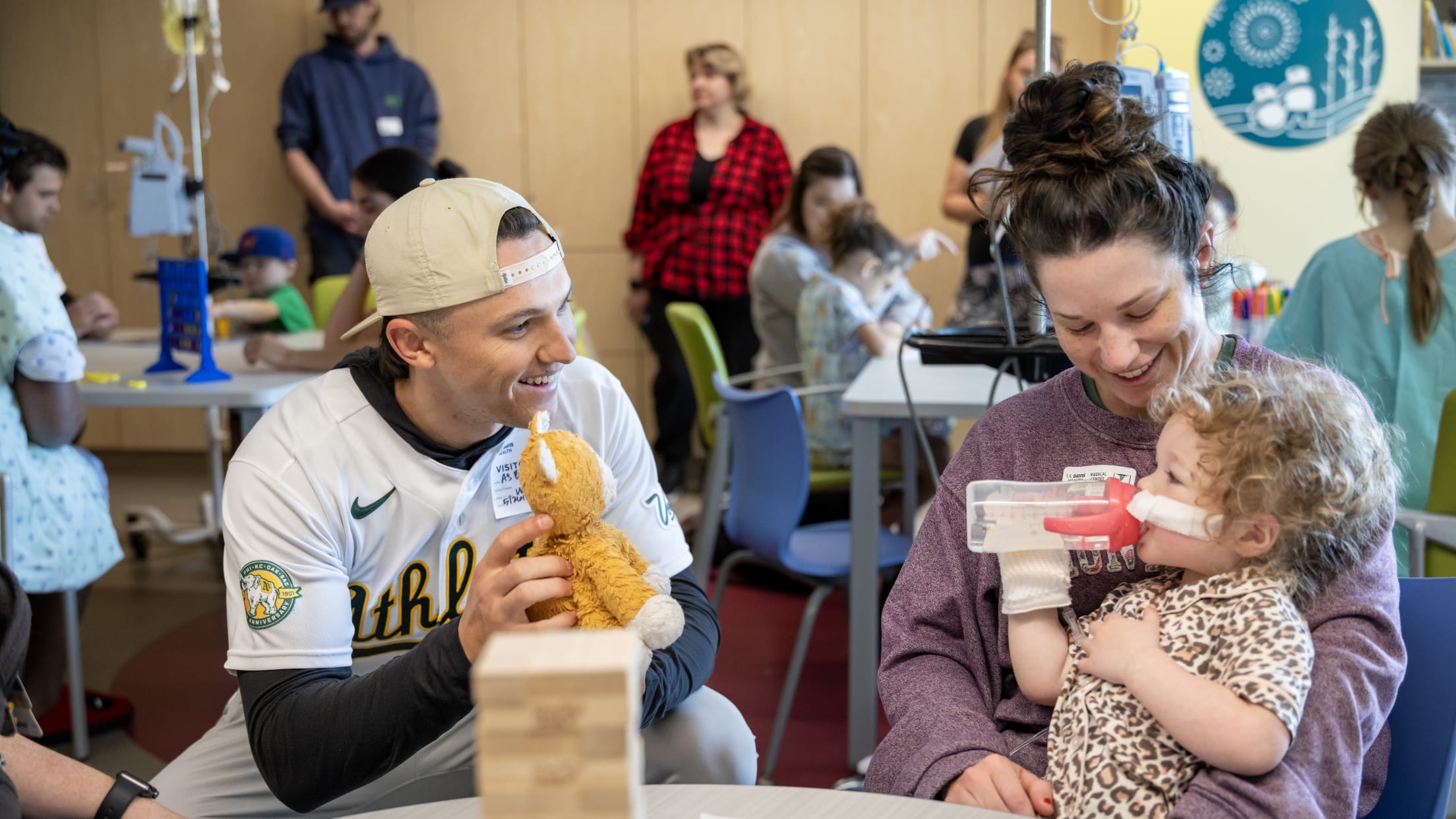 Zack Gelof plays with a young patient at Shriners Children's Hospital.