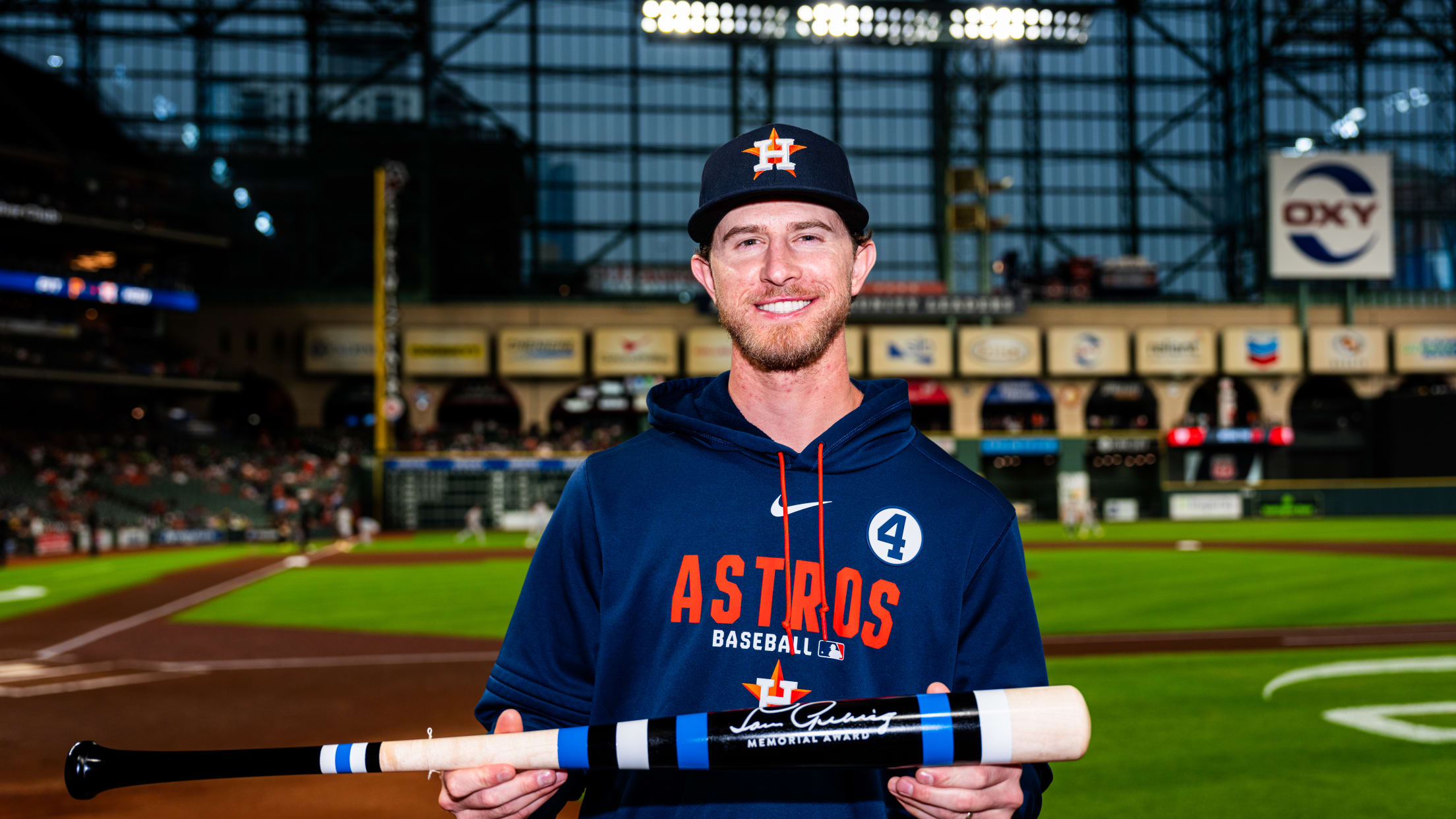 Josh Hader holds a Lou Gehrig Memorial Award bat during pregame ceremonies at Daikin Park.