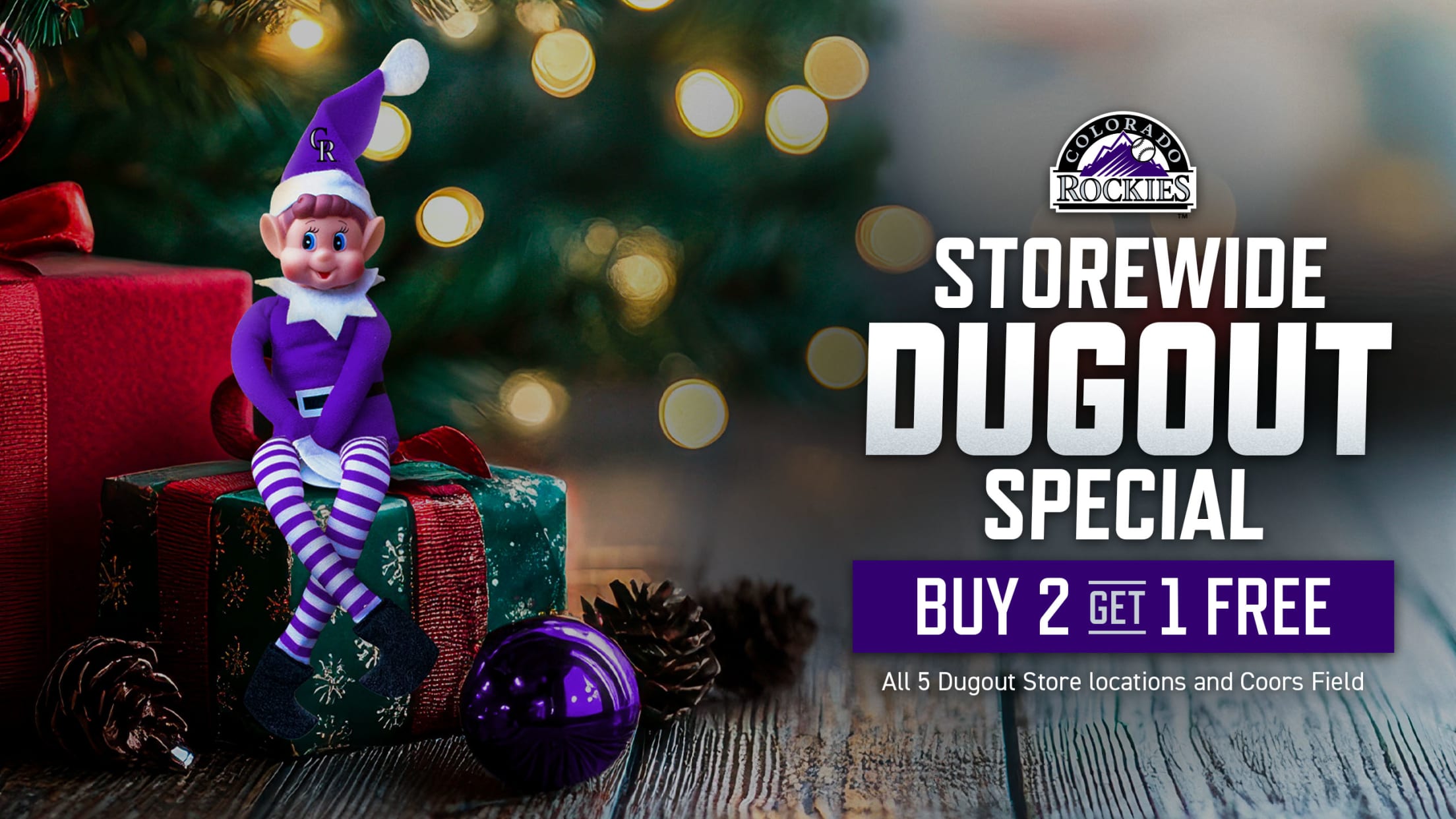 Storewide Dugout Store Special - Buy 2 get 1 free! Offer valid at all 5 Dugout Stores and Coors Field. Purple Colorado Rockies elf on top of presents