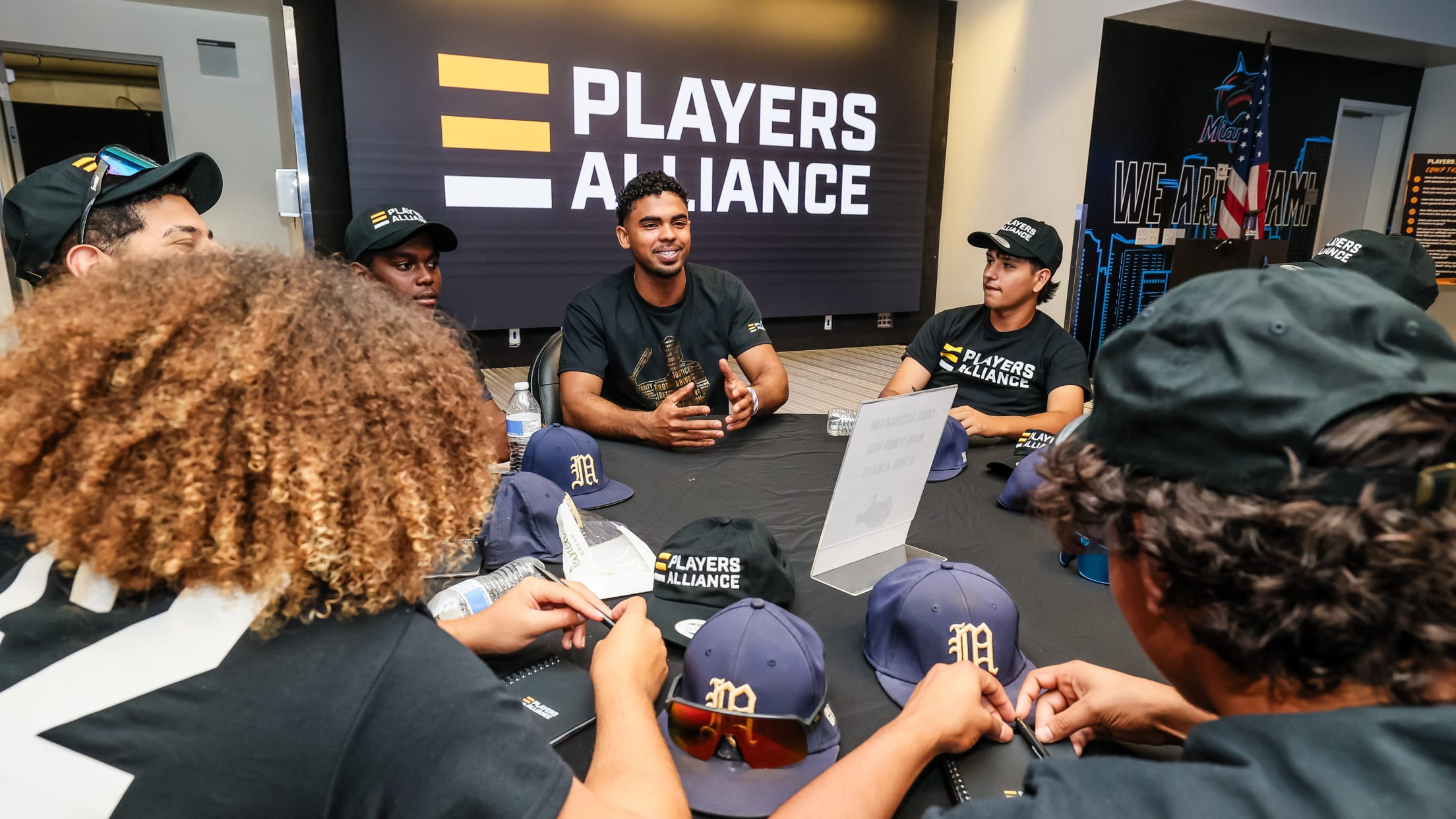 Players sit around a table and talk at The Players Alliance Equip the Future Clinic.