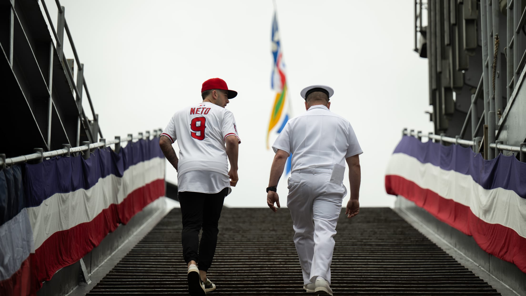 Zach Neto walks with a United States service member.