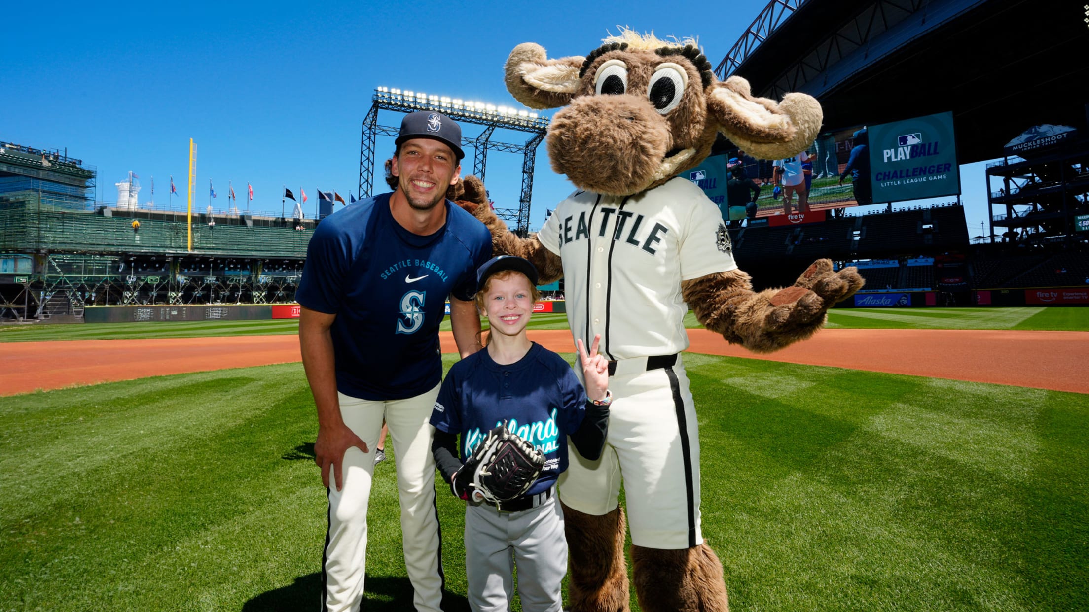 Logan Gilbert and Mariner Moose posing with young fan.