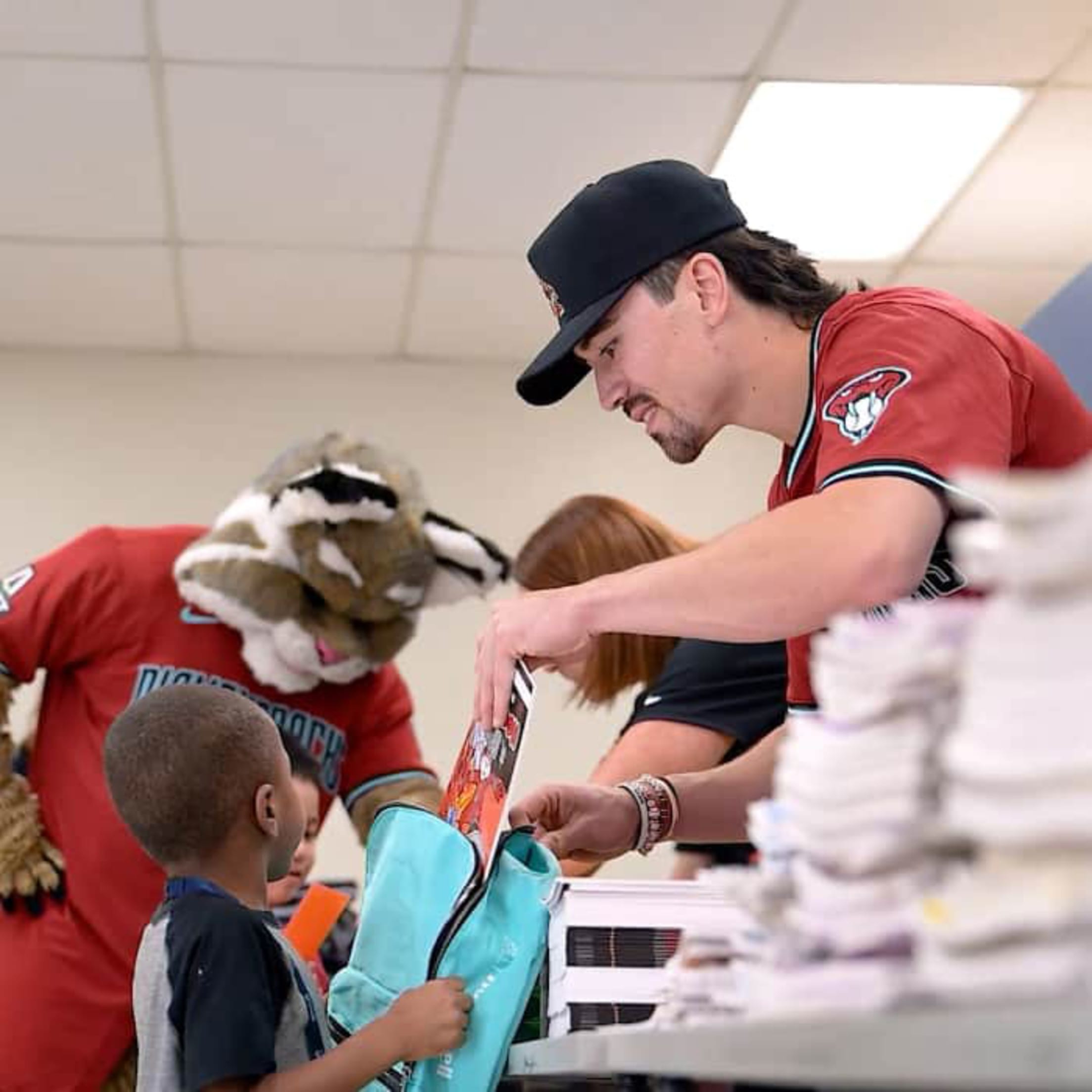 Corbin Carroll helps with new backpacks and school supplies.