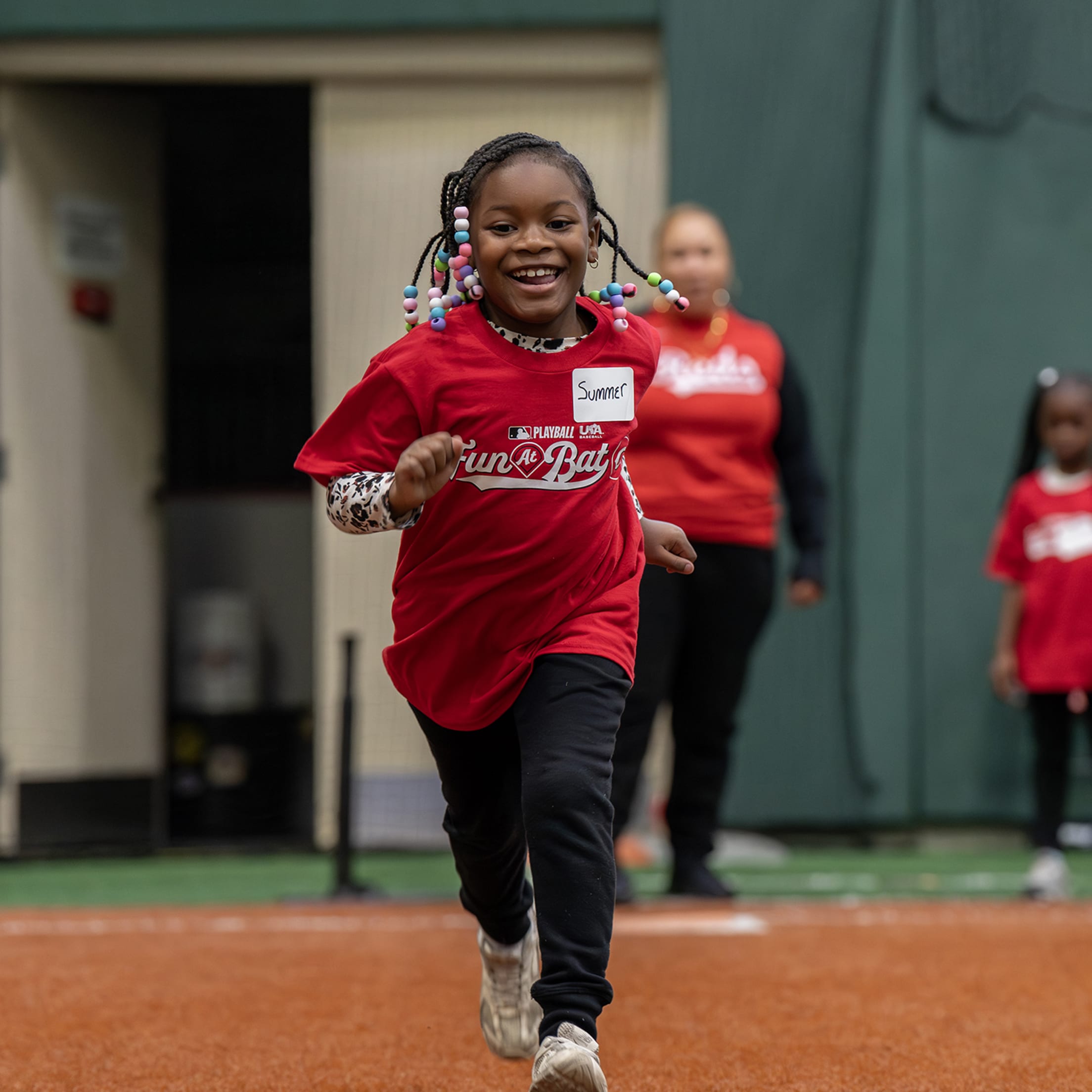 Fun At Bat participant runs the base line with a big grin after getting a hit.