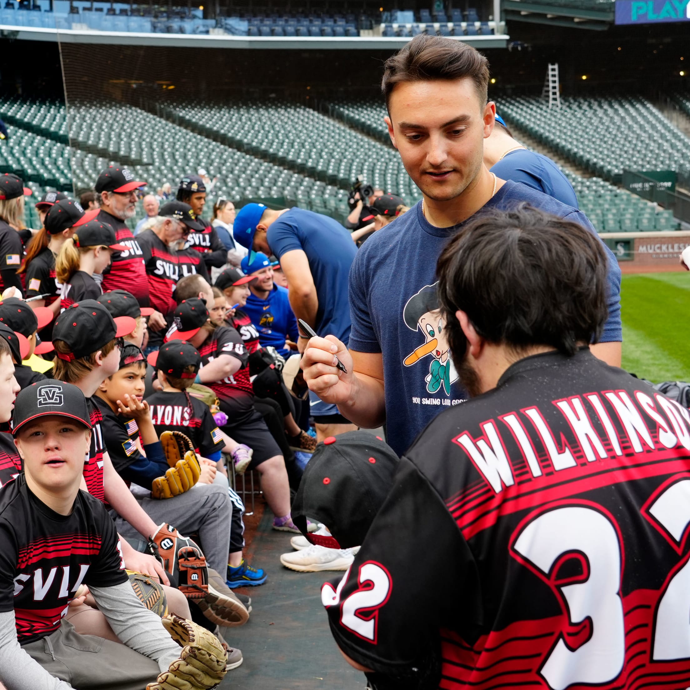 Dominic Canzone signing autograph for fan.