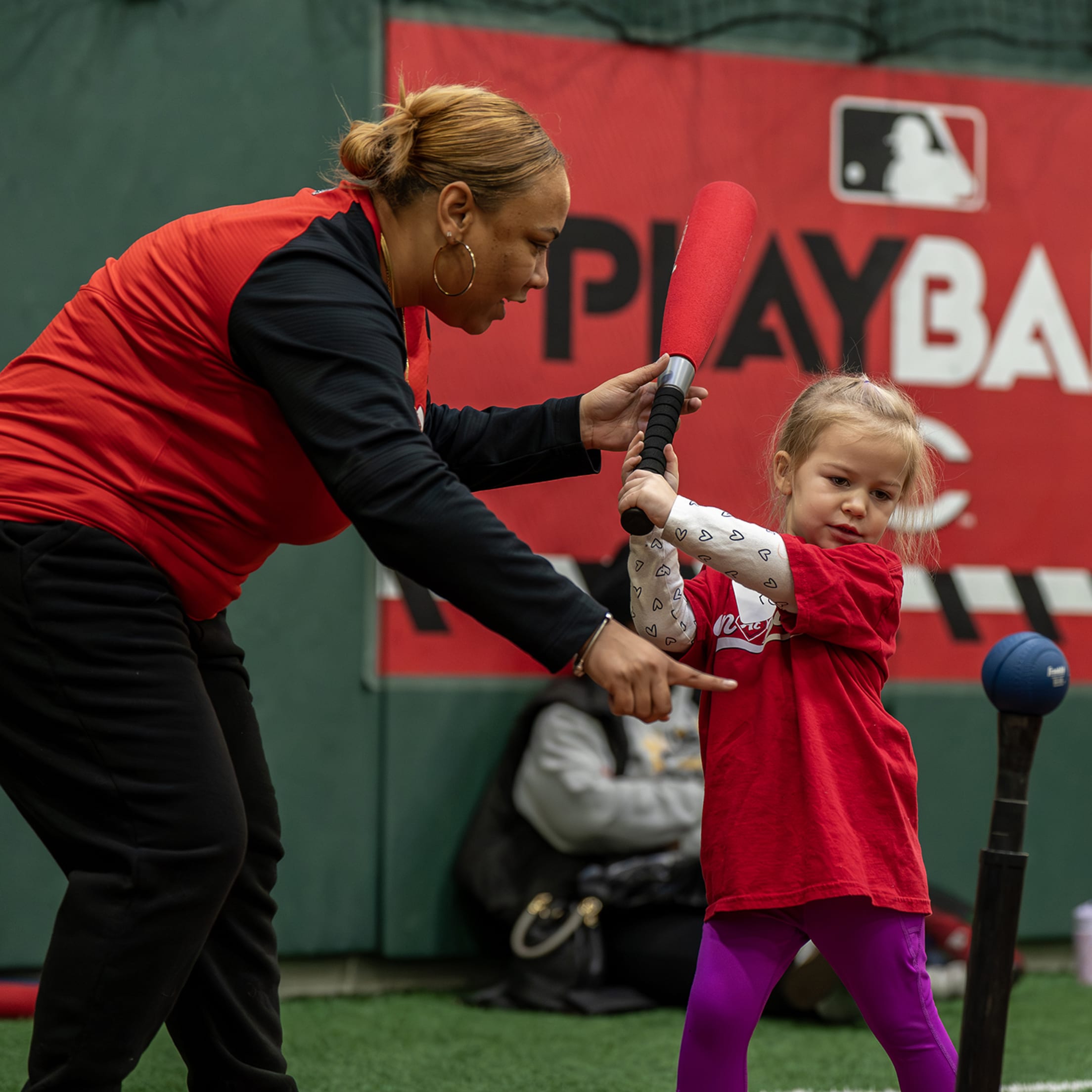 Fun At Bat instructor helps young participants with swing.