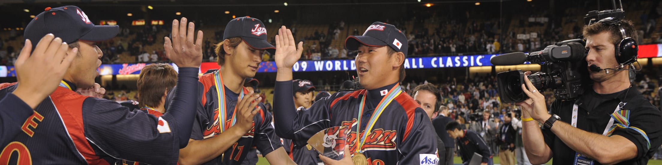 Japan's Daisuke Matsuzaka high-fives his teammates after defeating Korea in the final game of the 2009 World Baseball Classic at Dodger Stadium.