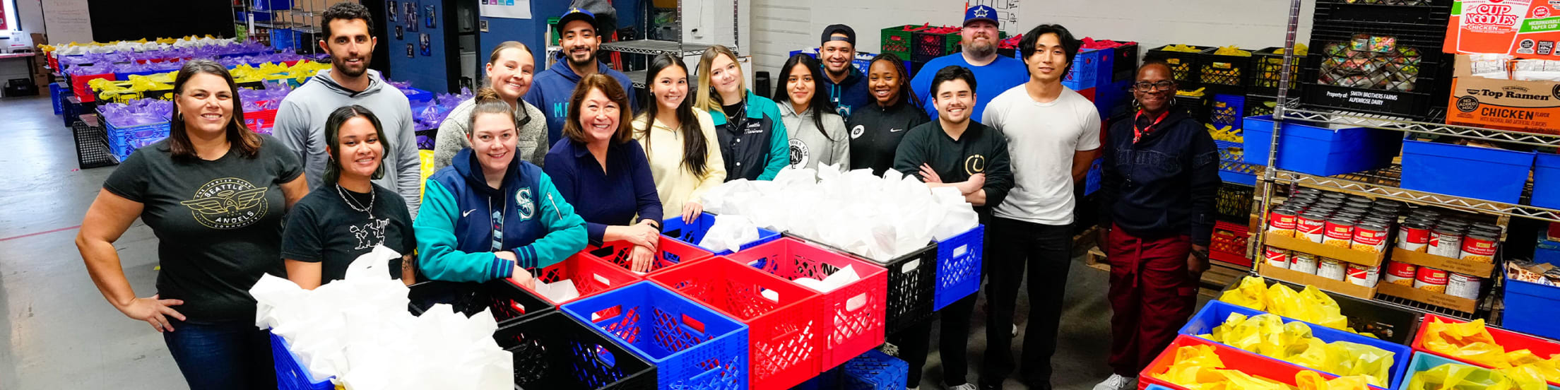 Image of Mariners Front Office staff packing donations.
