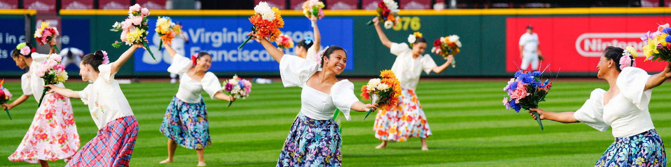 Image of dance group performing on the field at T-Mobile Park.