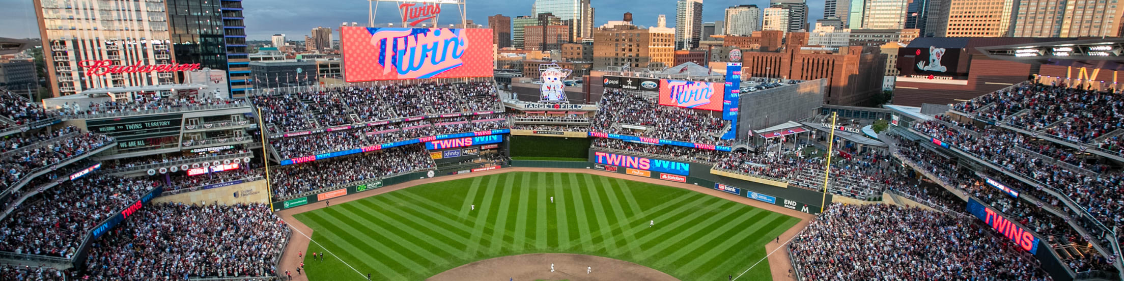Bird’s eye view of Target Field on cloudy evening with Minneapolis skyline in background