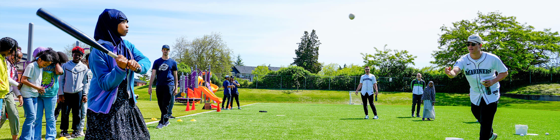 Bryan Woo and Cal Raleigh playing baseball at local school.