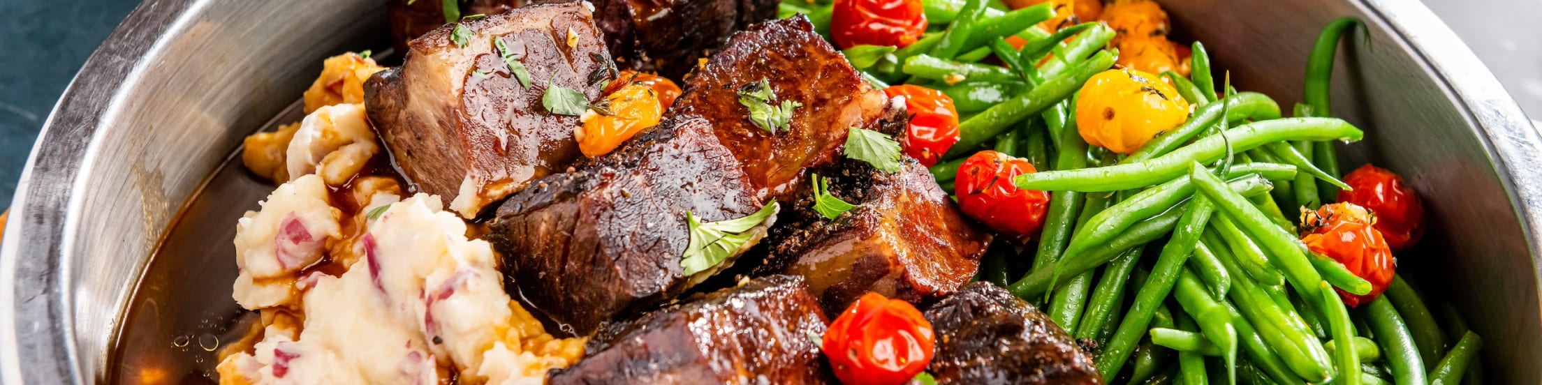 Beef Short Rib with red skinned mashed potatoes, green beans, roasted garlic demi-glace & heirloom cherry tomatoes.