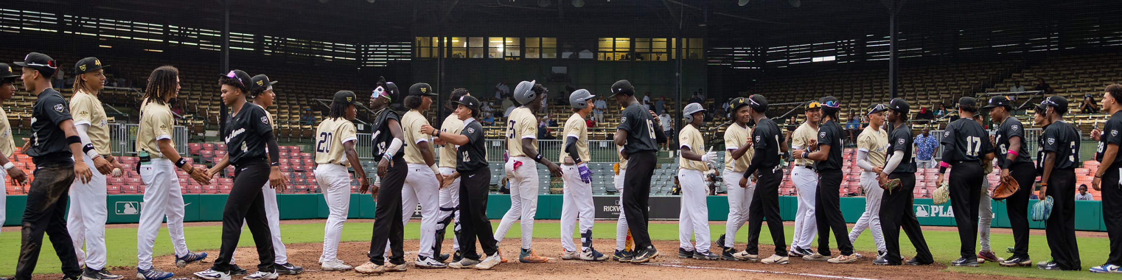 Hank Aaron Invitational participants shake hands after a game.