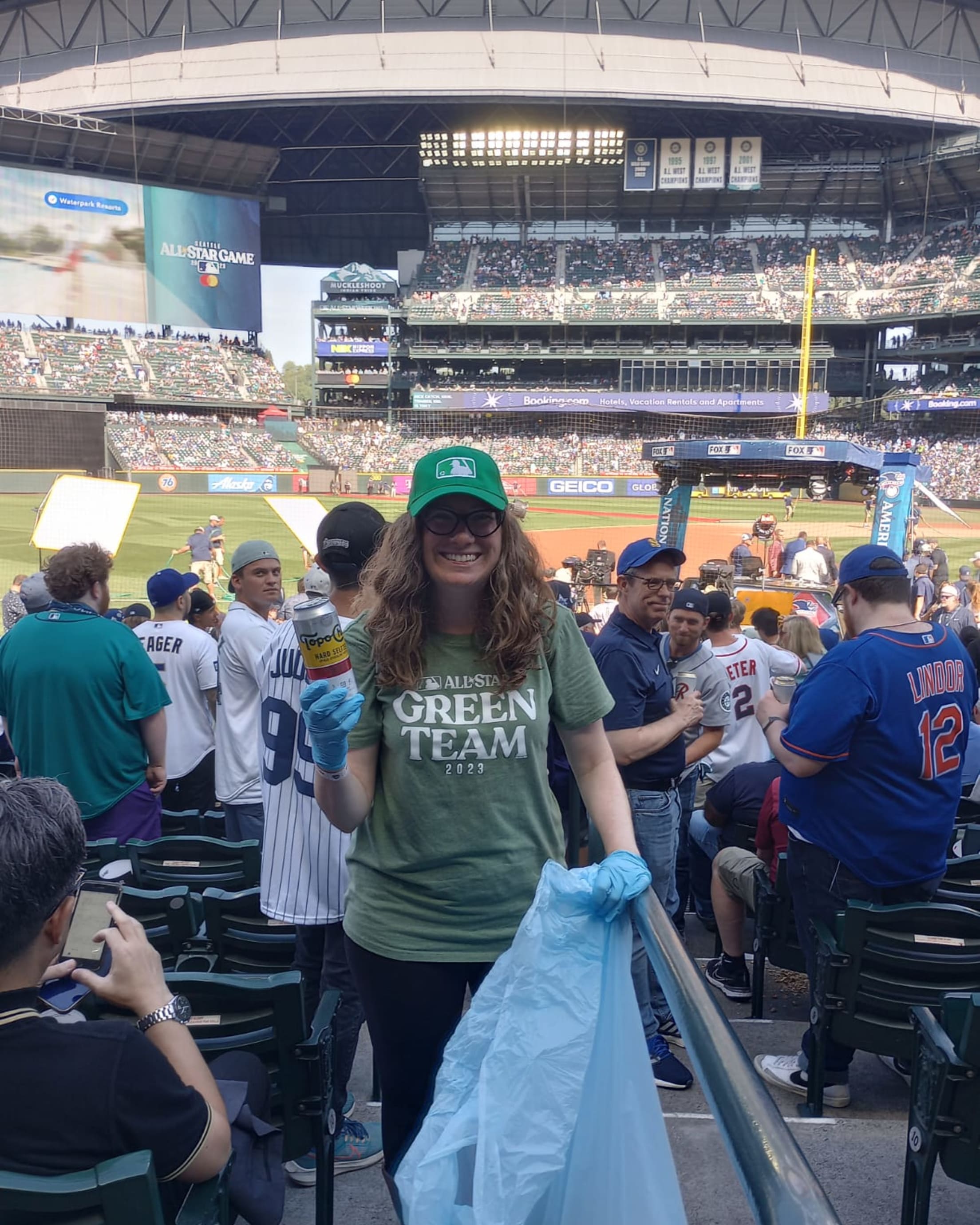 A Green Team member collects recyclables at the 2023 All-Star Game in Seattle.