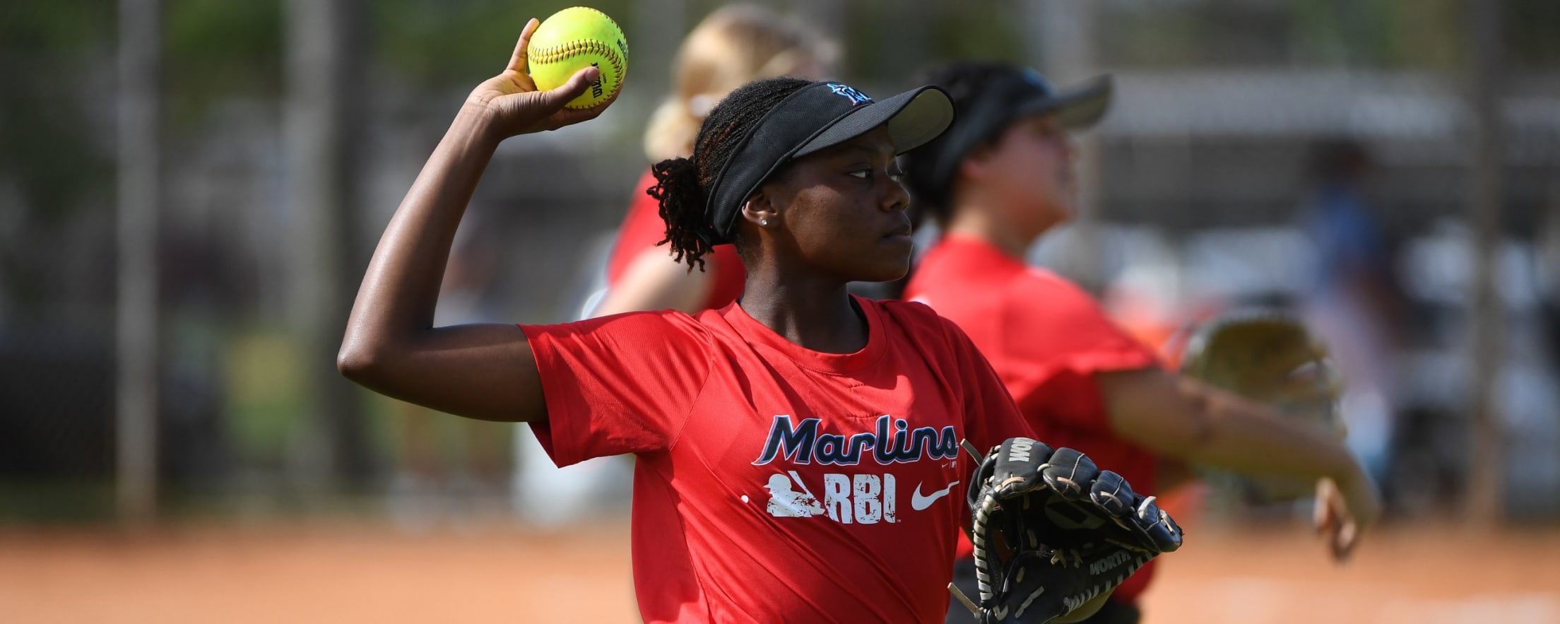 Marlins RBI participant throwing a softball