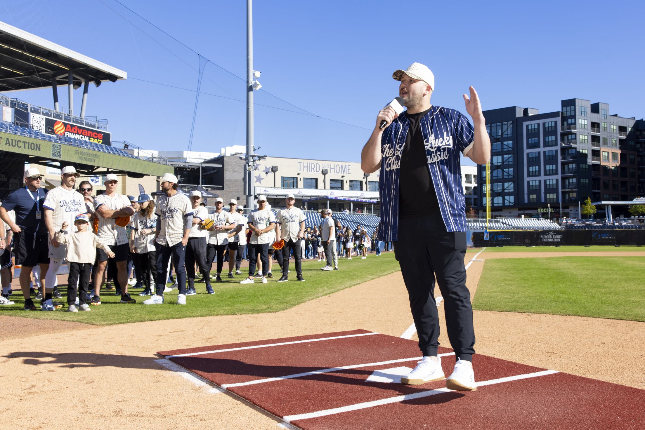 Jake Burger takes the mic to talk to participants of the Celebrity Softball Game.