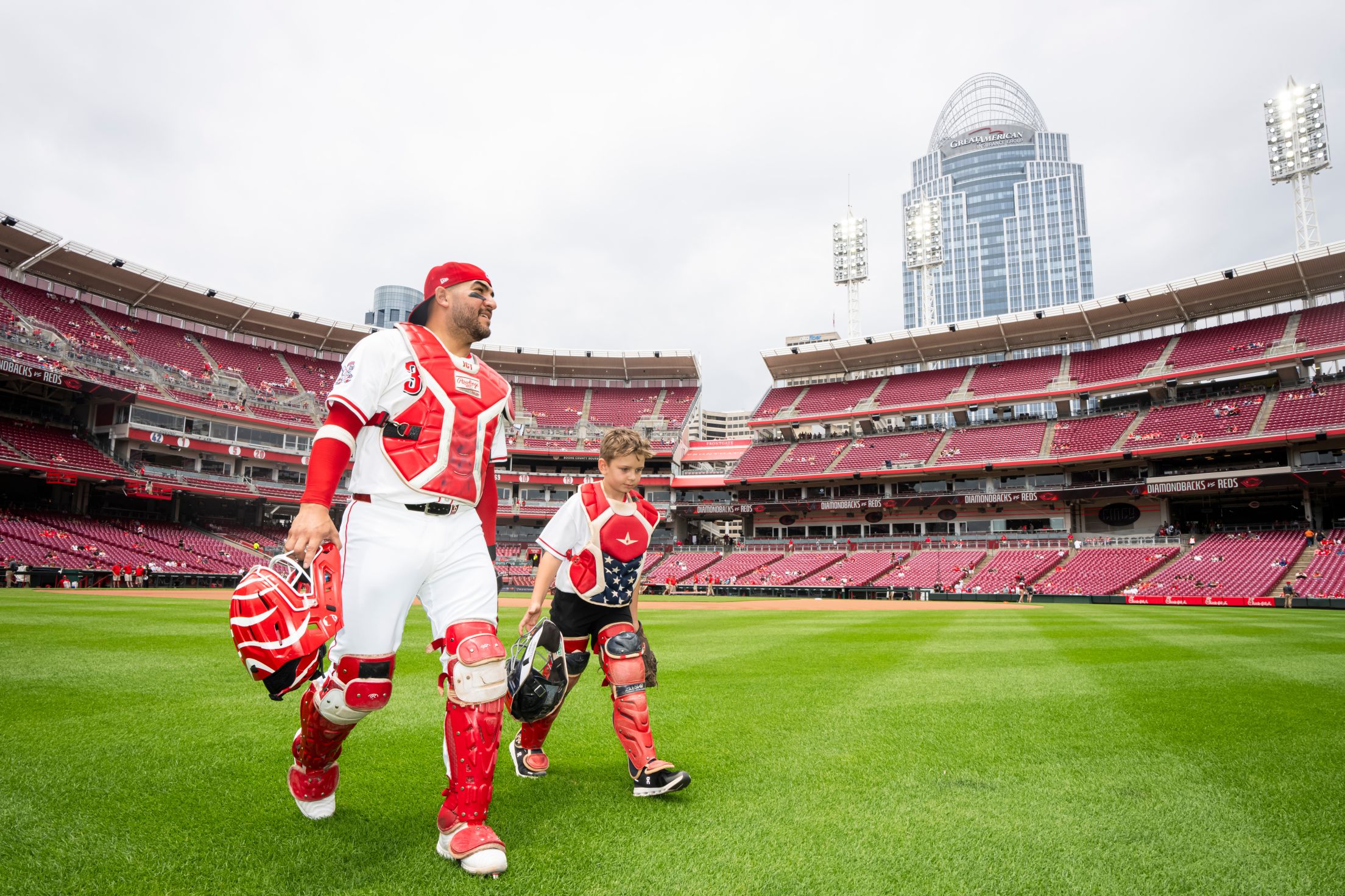 Jose Trevino takes the field with child from the Make-A-Wish foundation.