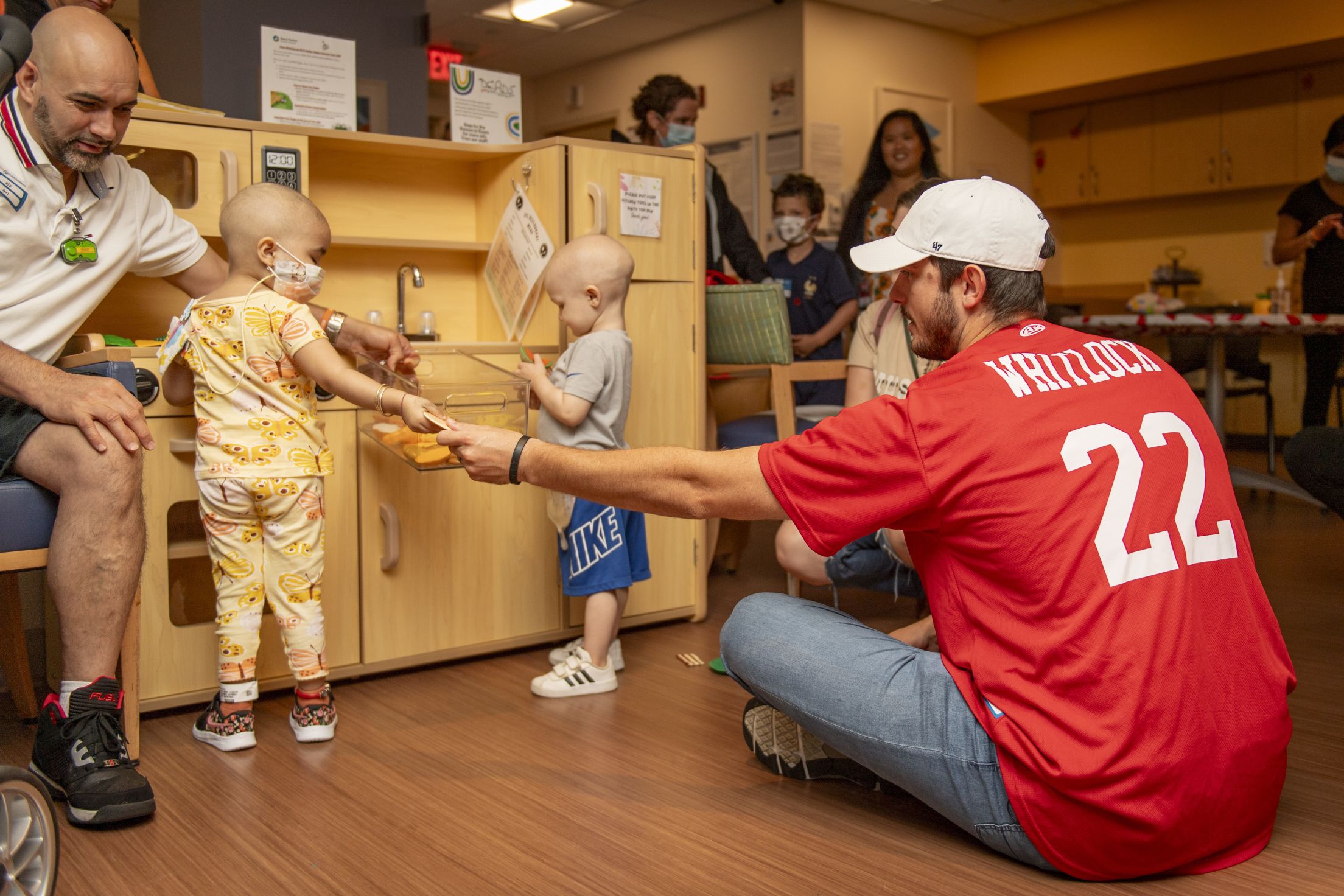 Garrett Whitlock plays kitchen with pediatric patients at Dana-Farber Cancer Institute.