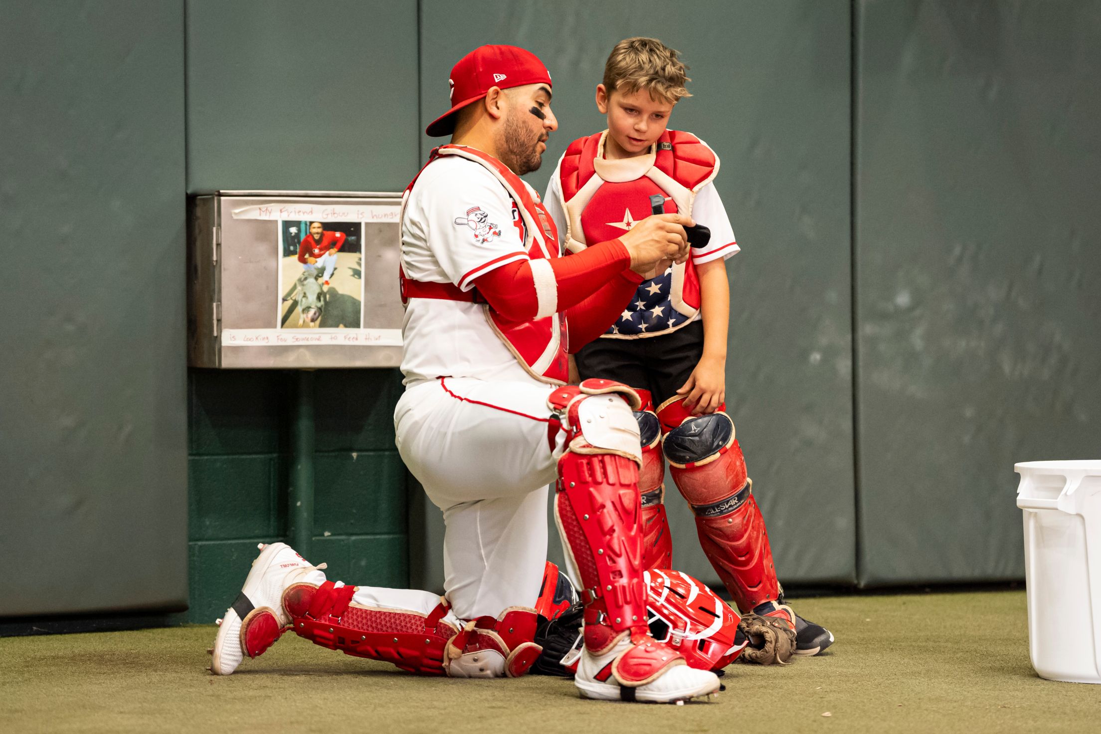Jose Trevino shows a child from the Make-A-Wish Foundation the ropes of being a MLB catcher.