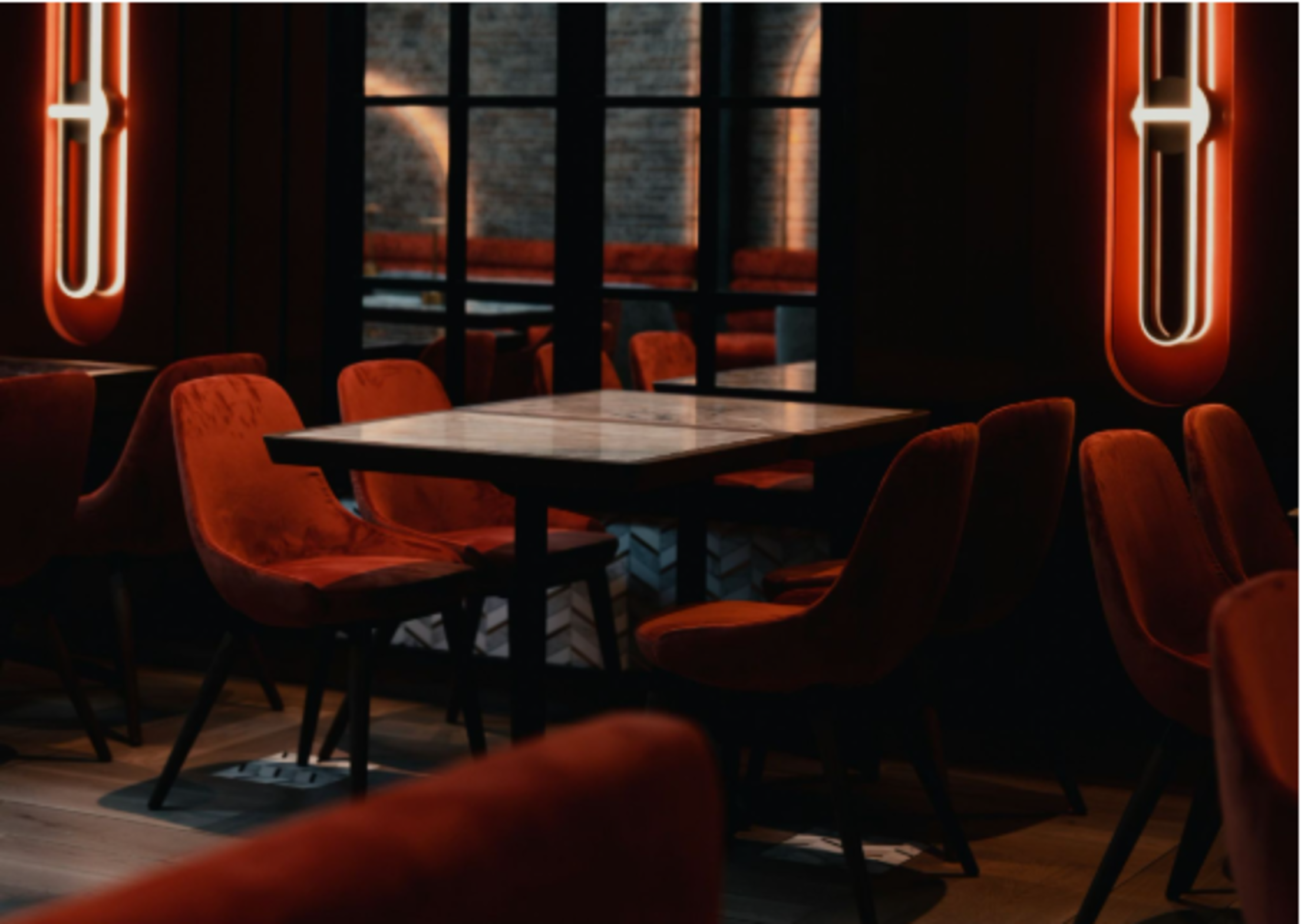 dimly-lit-lounge-neon-velvet-chairs