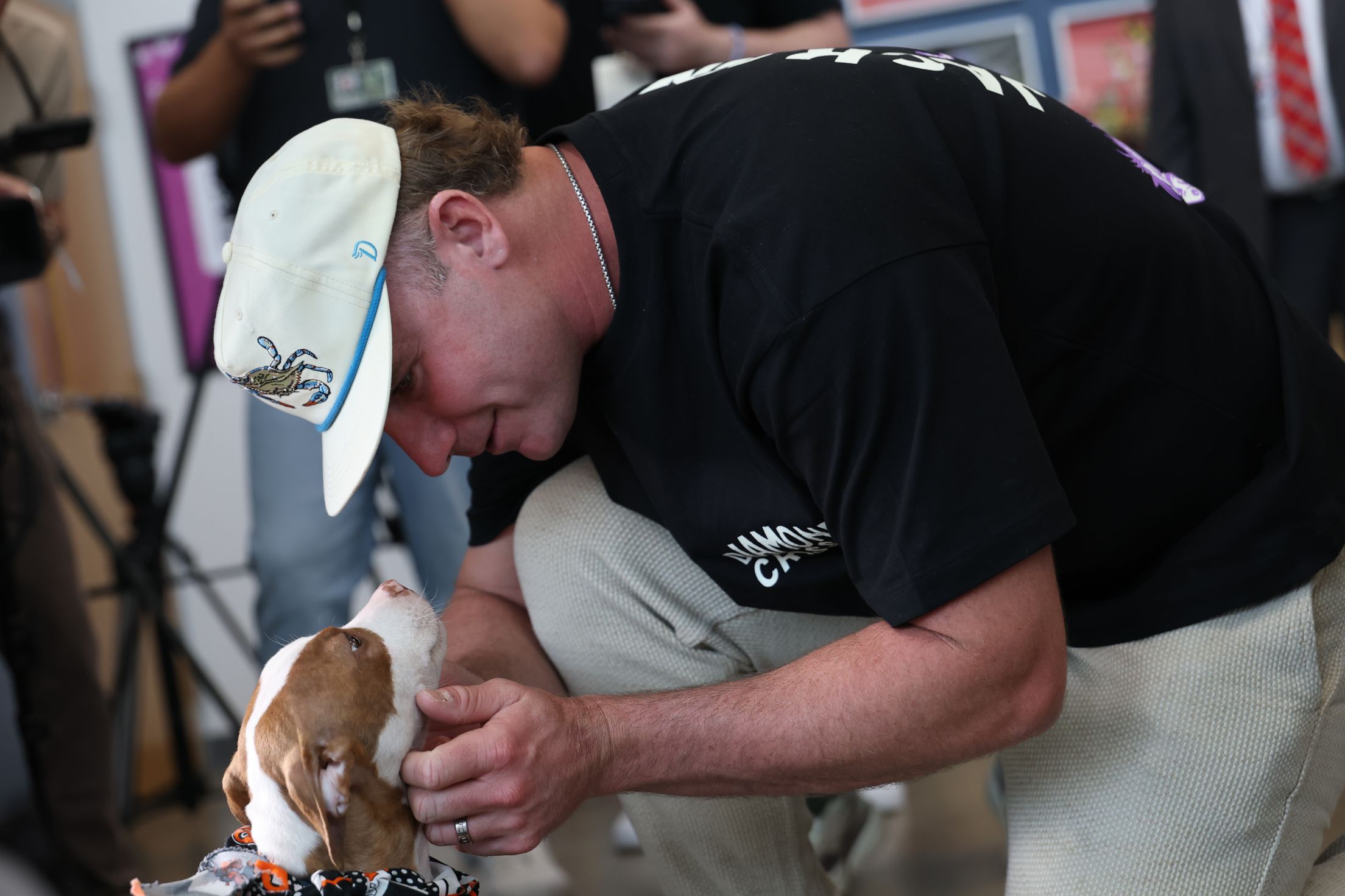Pete Alonso plays with a pup at an event with Baltimore Animal Rescue and Care Shelter (BARCS).
