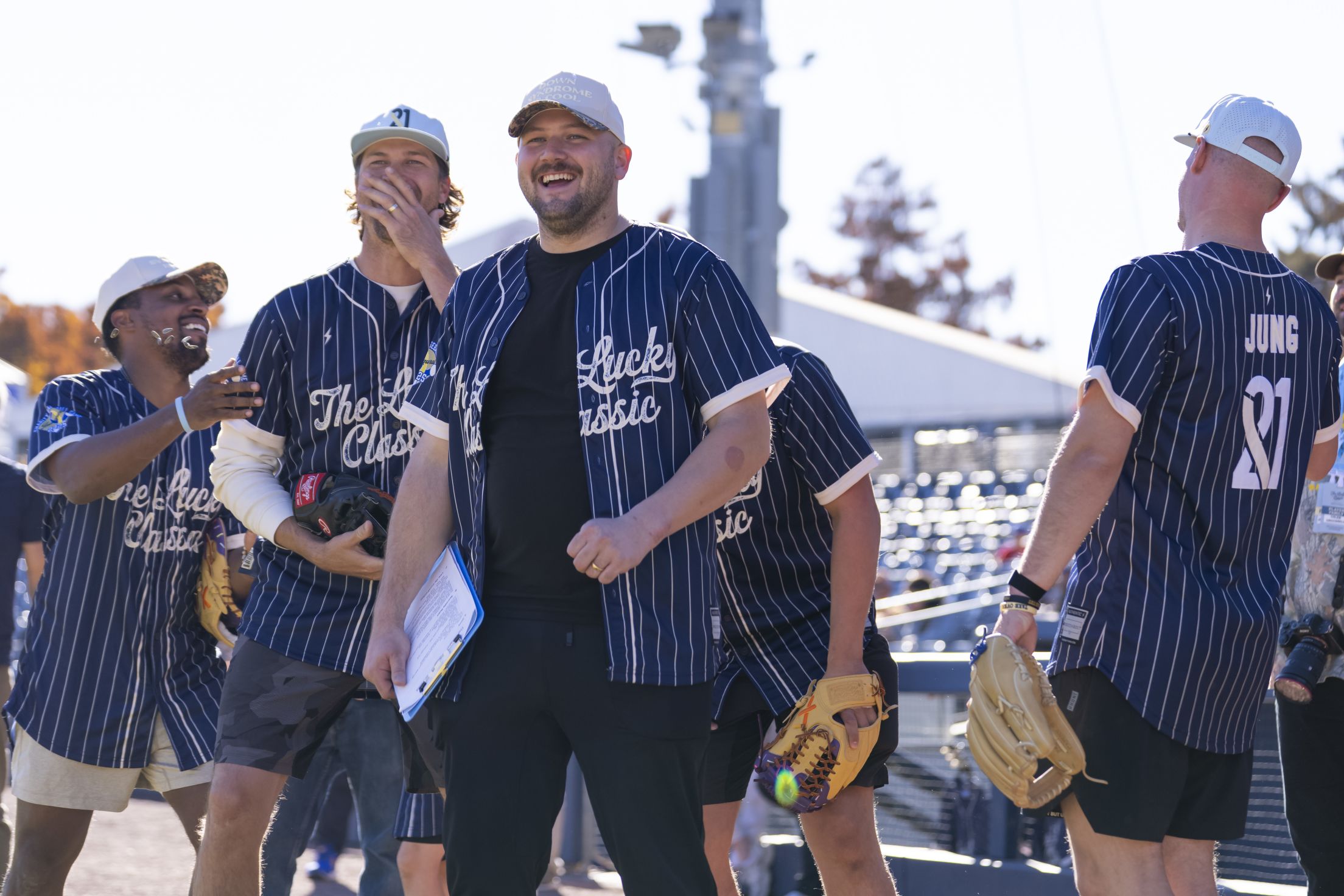 Jake Burger jokes around with others at the Celebrity Softball Game.