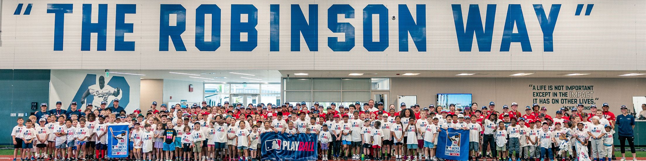 Children outside "The Robinson Way" signage.