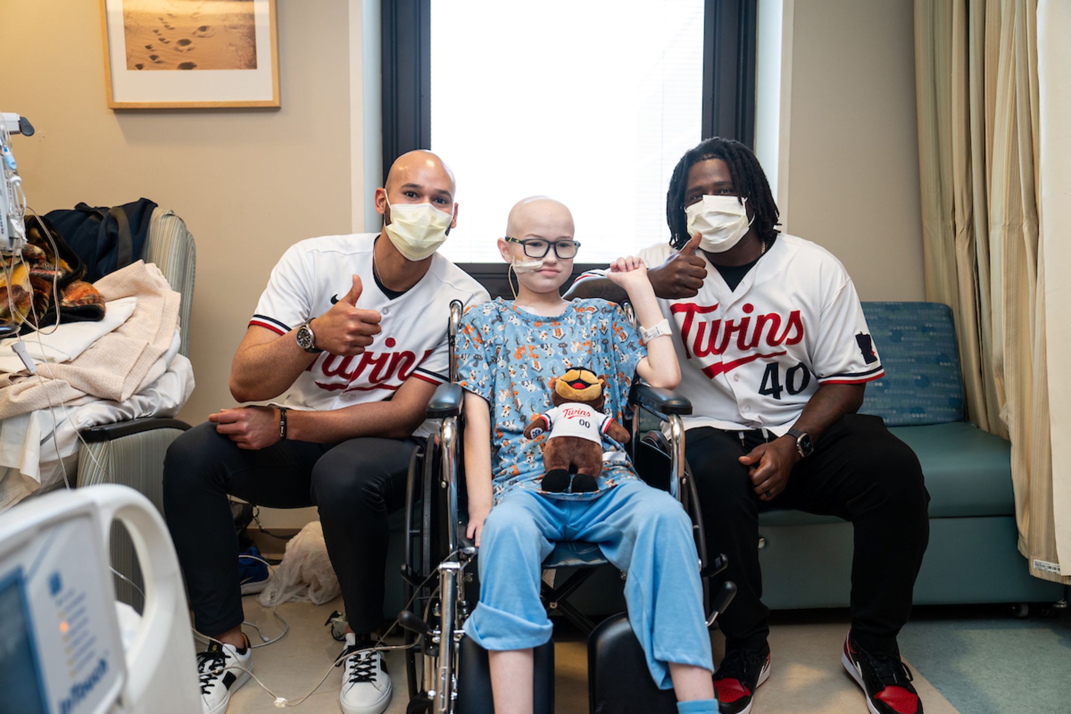 Pablo López and Tommy Watkins take a picture with a fan at the Minnesota Children's Hospital.