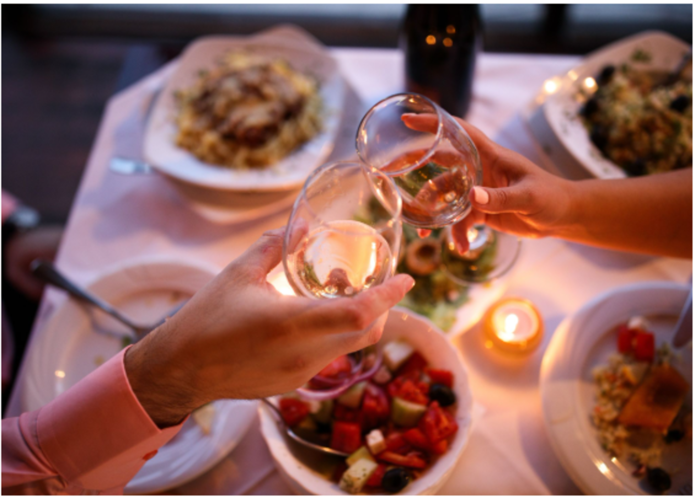 couple-toasting-wine-candlelit-dinner